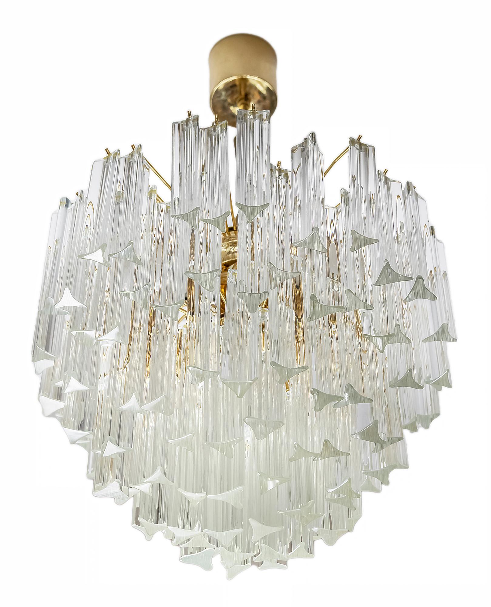 This mid-century Italian chandelier is made of brass with clear Murano glass. 
Chandelier includes 4 pieces of E14 bulbs.
It is heavy.