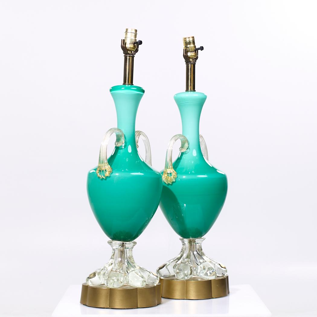 Mid Century Italian Murano Teal Cased-Glass Double-Handled Urn-Form Lamps - Pair

Each lamp measures: 8 wide x 7.5 deep x 27 inches high

We take our photos in a controlled lighting studio to show as much detail as possible. We do not Photoshop out