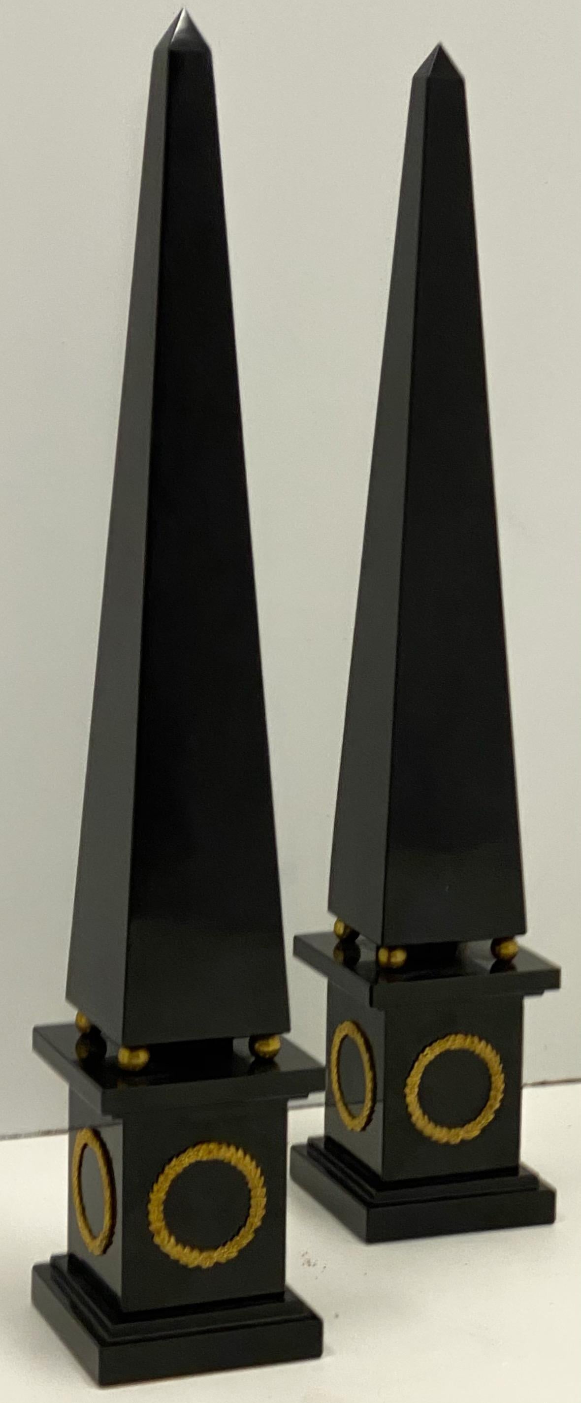 This is a pair of Italian neoclassical style marble obelisks with gilt accents. They are unmarked and in very good condition. The bottoms are lined with felt.