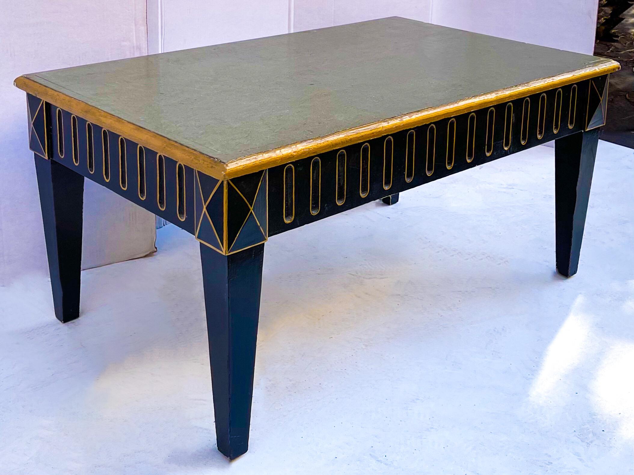 This is a mid-century Italian neo-classical style painted coffee table with faux marble top. The edges are giltwood, while the base is both black and gilt. The top is a green toned faux marble mottled finish.