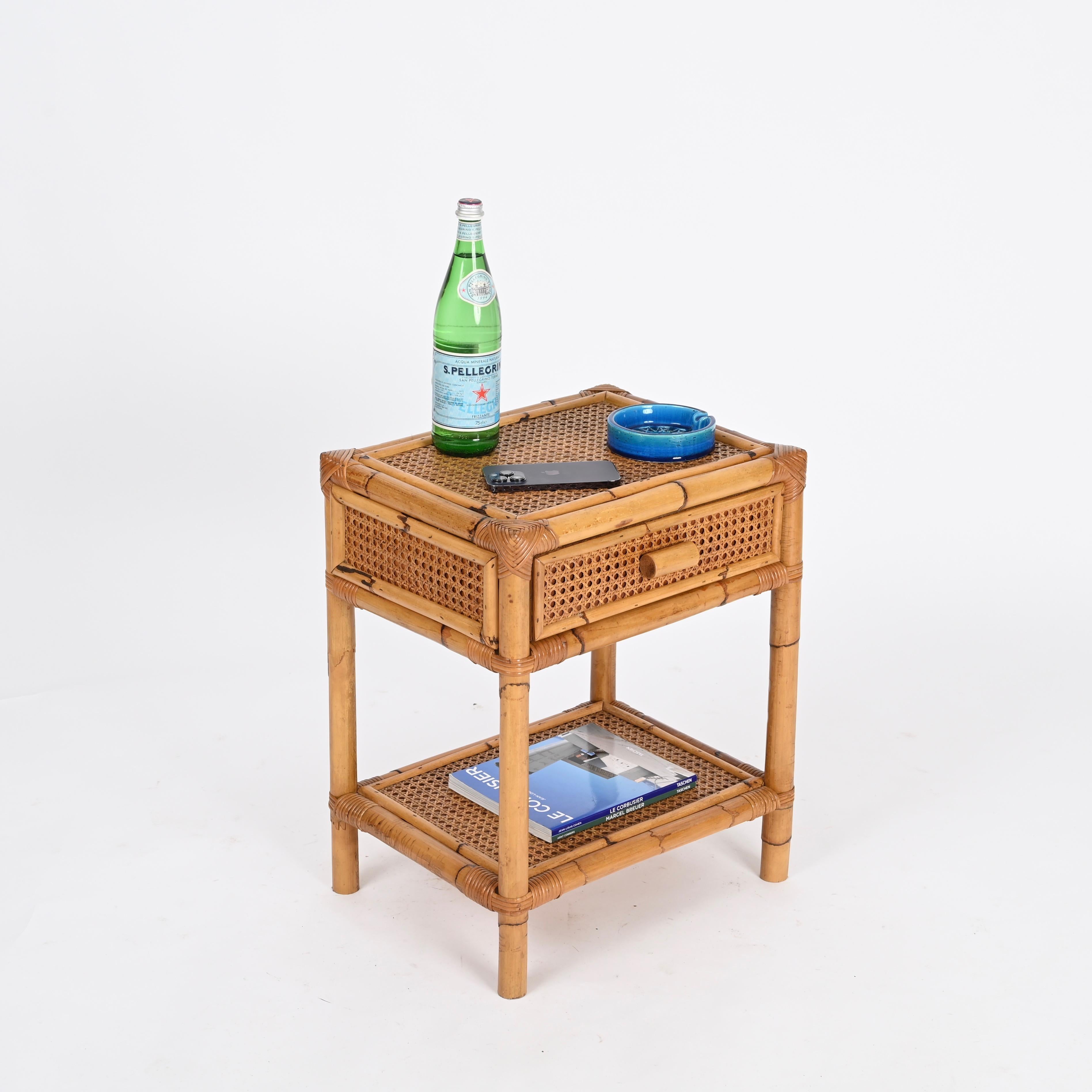 Delightful Mid-Century nightstand or side table in bamboo, Vienna Straw and hand-woven rattan wicker. This charming organic bedside table was designed in Italy during the 1960s.

This stunning French Riviera style nightstand is in amazing conditions