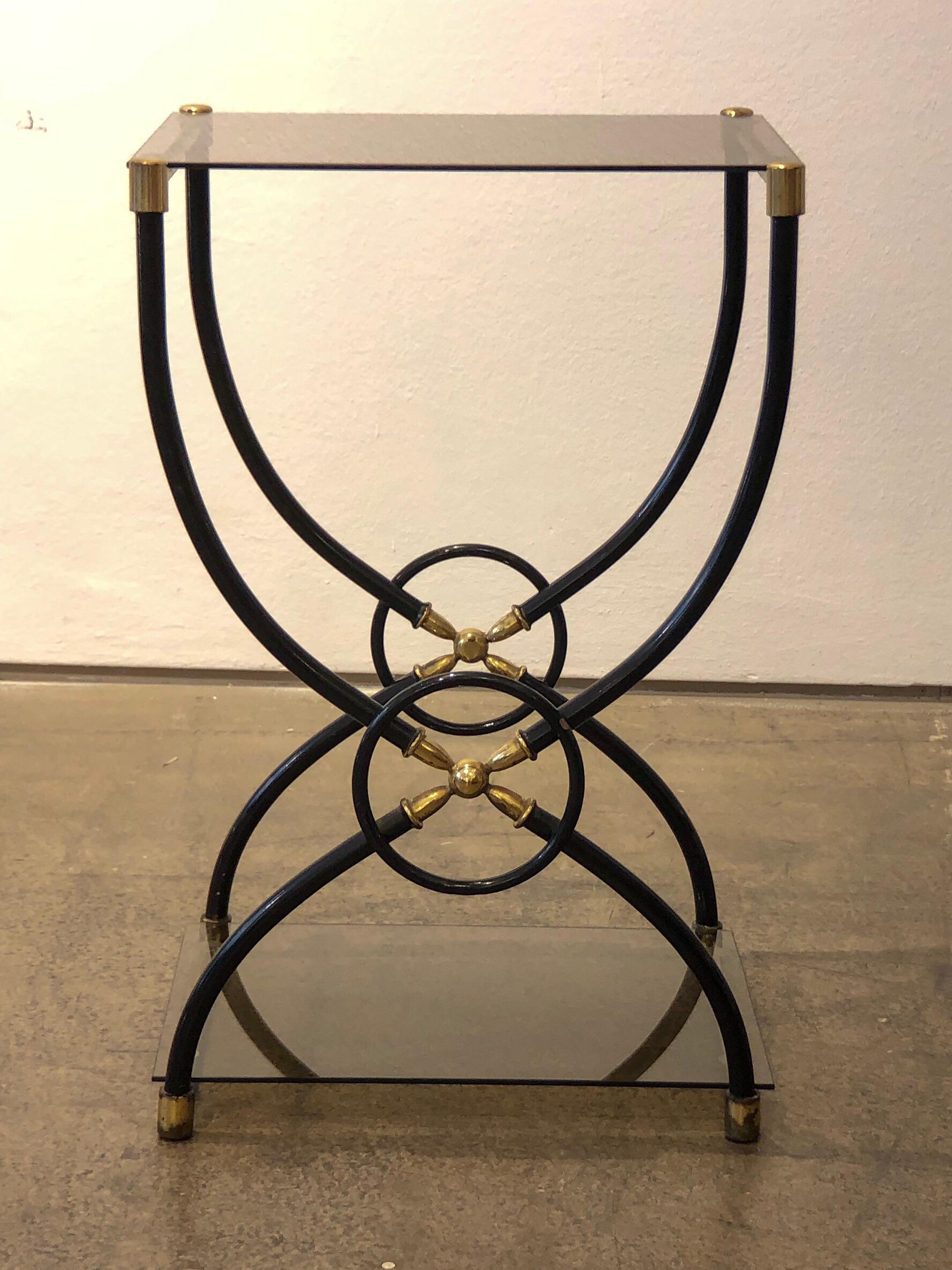 Very elegant midcentury nightstands from Italy from the 1960s. The nightstands can also be used as side tables.
The metal frame is mostly lacquered in black and has a brass squared frame at the top and the bottom. The middle part where the S-shaped