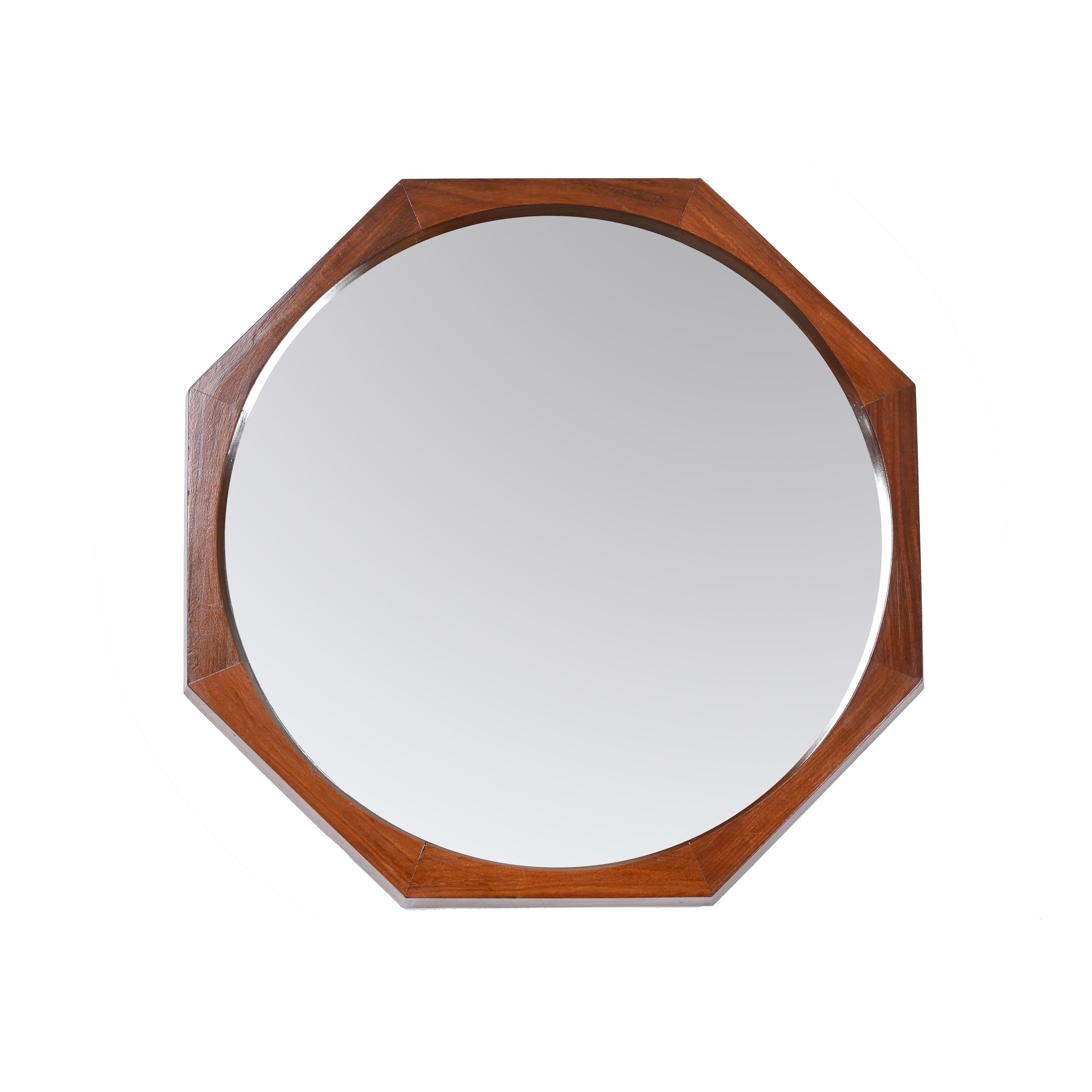 Amazing Mid-Century  teak wood octagonal wall mirror. This fantastic piece was designed by Franco Campo and Carlo Graffi in Italy in the 1960's.

This wonderful piece features an octagonal frame in teak wood of outstanding quality with marvellous