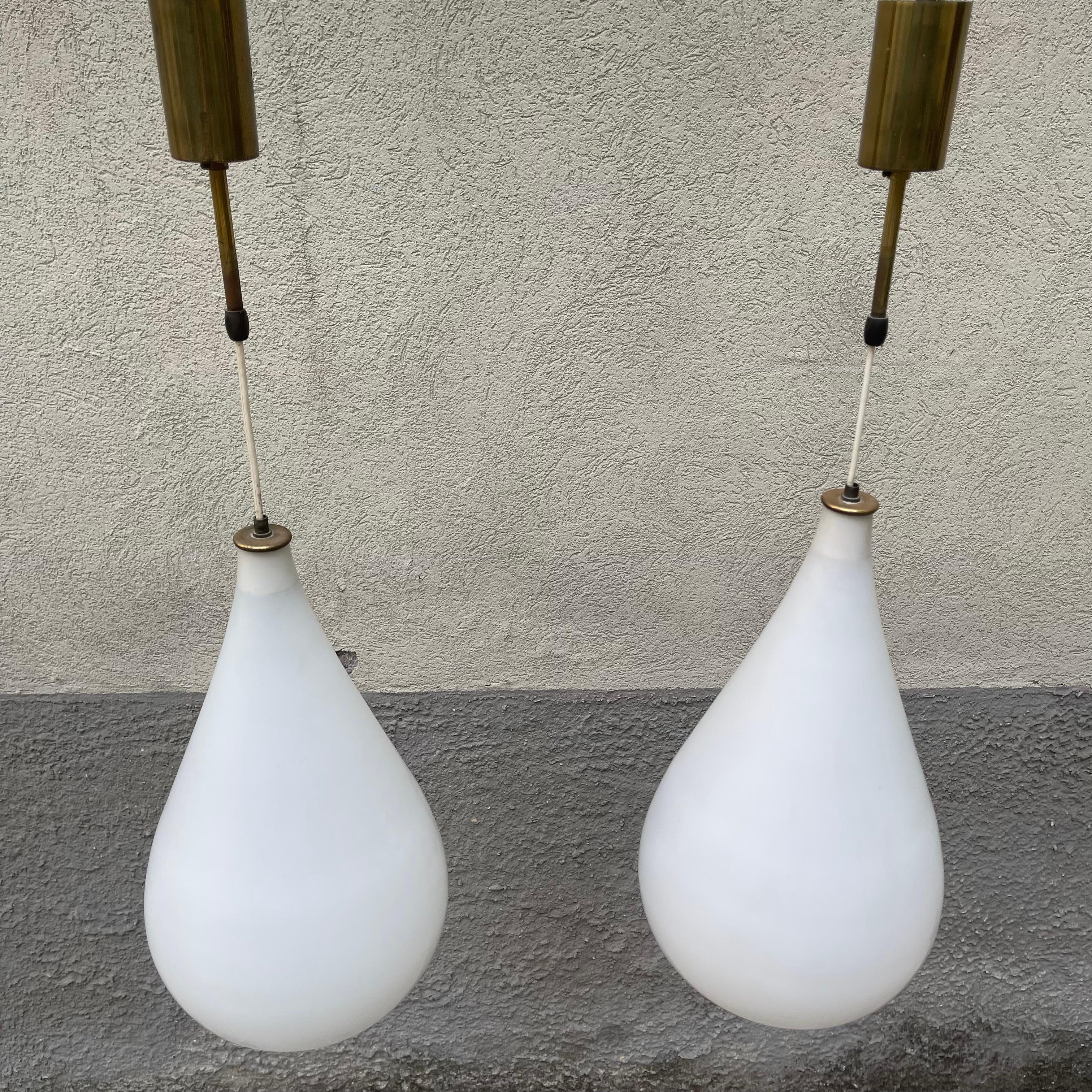 A frosted, mold-blown, Italian-made glass chandelier or pendant. A timeless tear-shaped piece in the style of Max Ingrand for Fontana Arte. The piece is elegantly blown in a sensual teardrop shape in frosted frosted glass. It is finished with solid