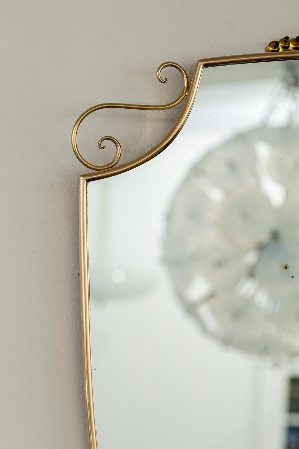 Mid Century Italian Oval Shield Shaped Mirror With Decorative Scrolls In Good Condition For Sale In Westport, CT