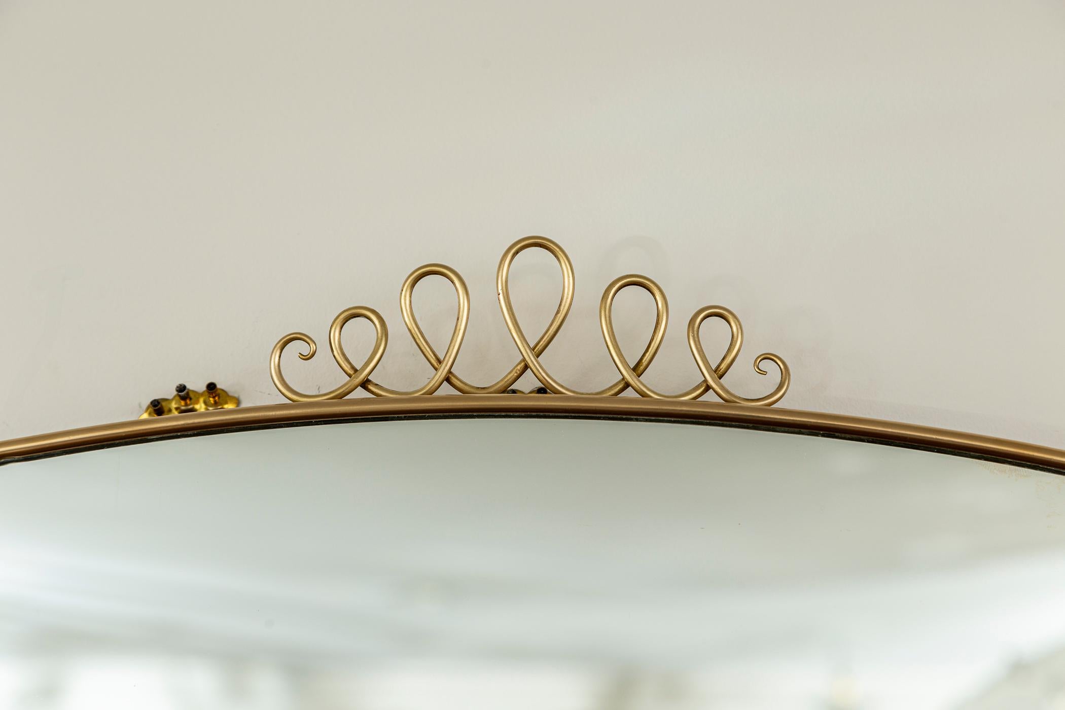 20th Century Mid Century Italian Oval Shield Shaped Mirror With Decorative Scrolls For Sale