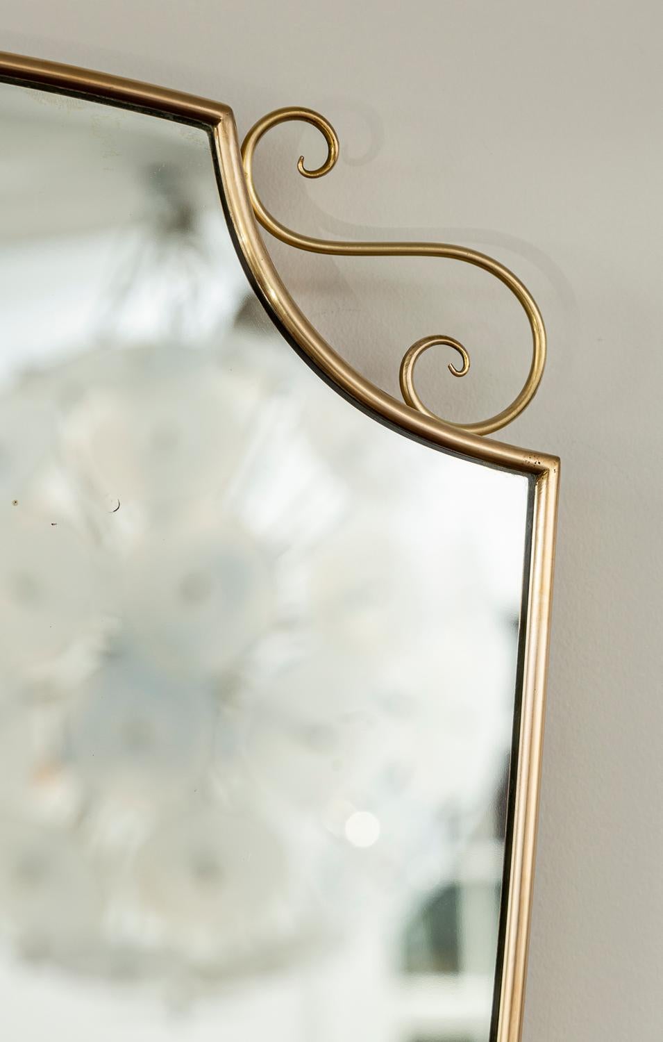 Brass Mid Century Italian Oval Shield Shaped Mirror With Decorative Scrolls For Sale