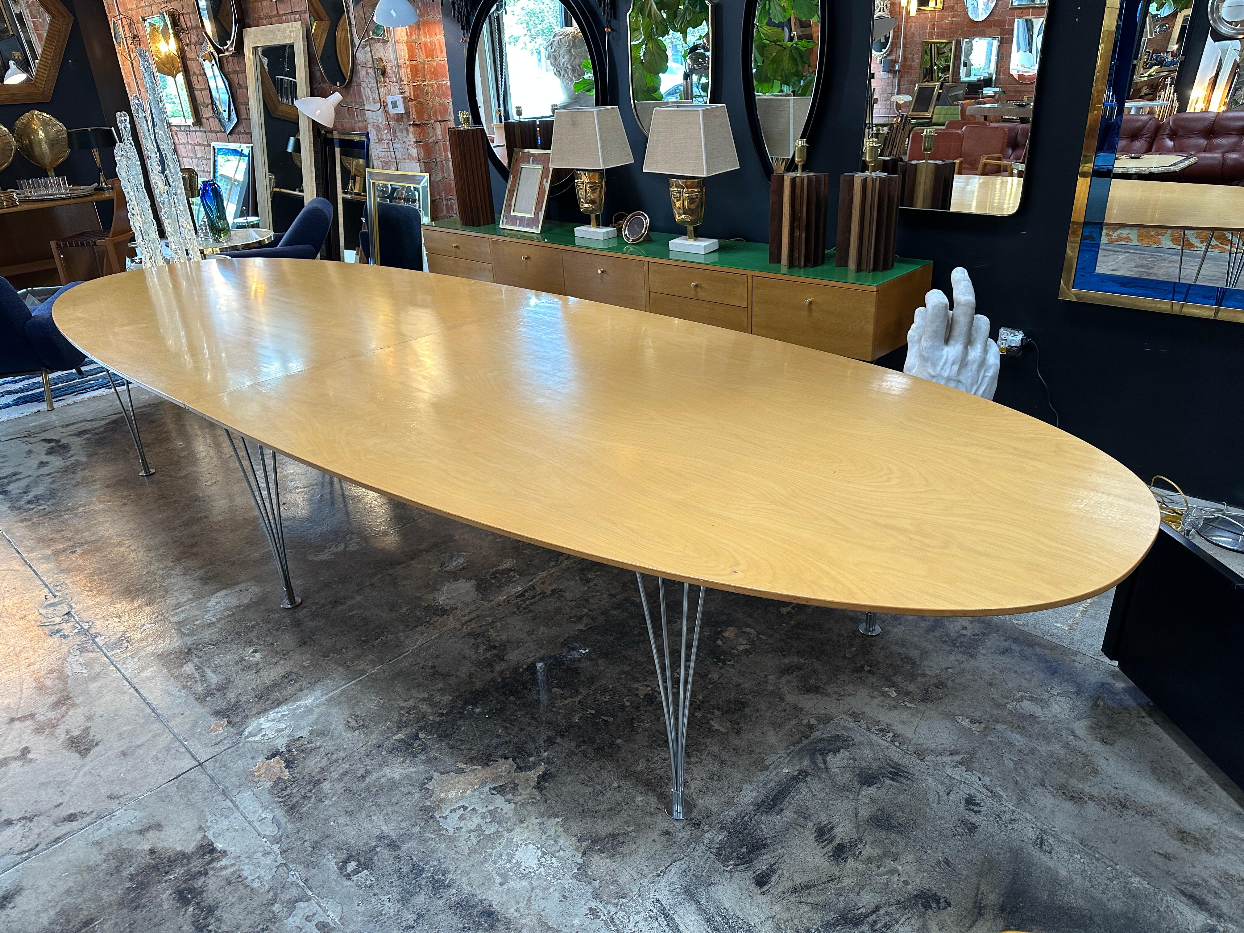 Experience timeless elegance with our Mid Century Oval Oversize Dining Table from the 1980s. This stunning piece features a sleek oval top crafted from wood, supported by six stylish chrome legs. The design captures the essence of mid-century modern