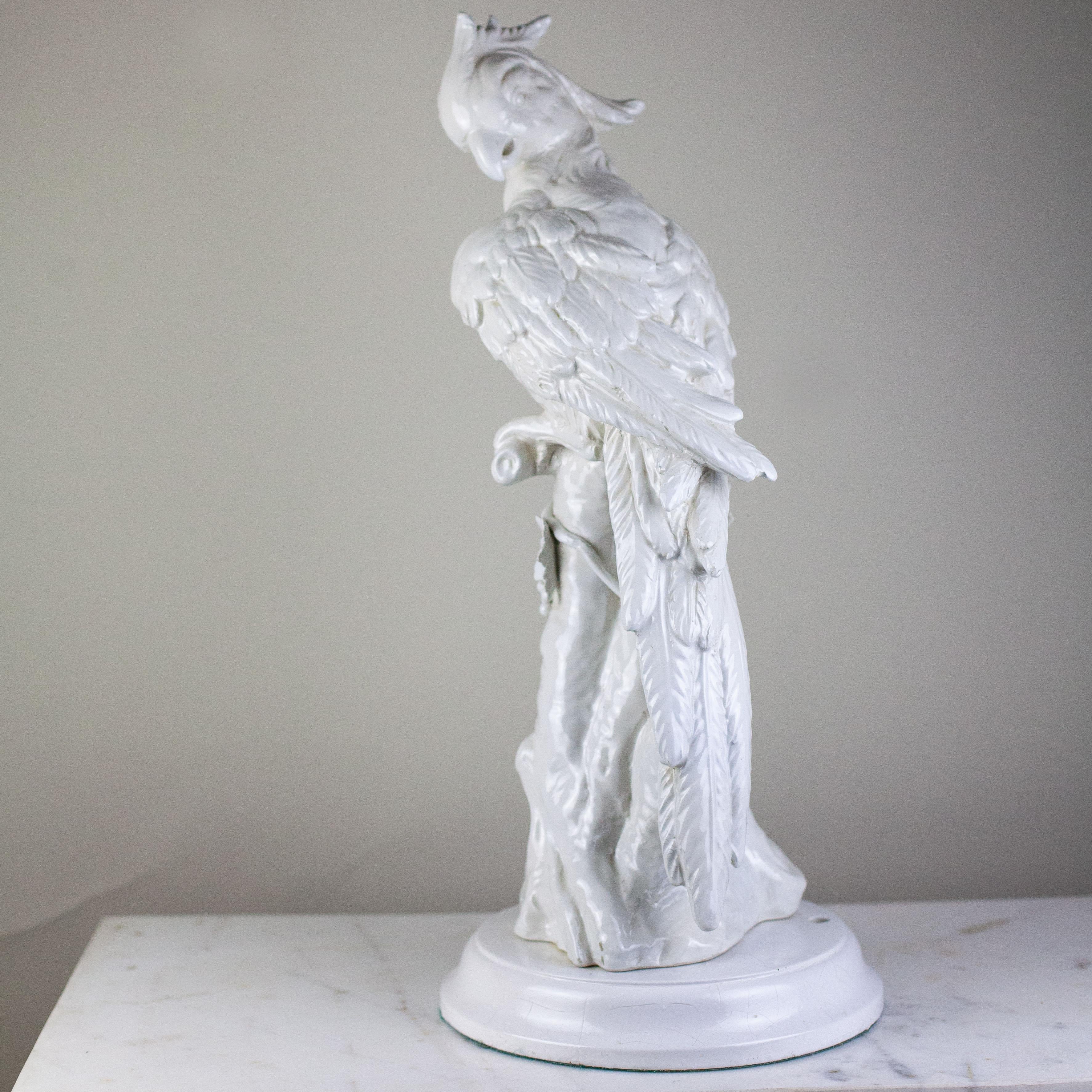 Fleurdetroit presents for your consideration, this fanciful sculpture depicting a cockatoo perched upon a tree trunk, in a classic white glaze. Originally a lamp base, this wonderous sculpture has impressive precence as a stand alone scultpture or