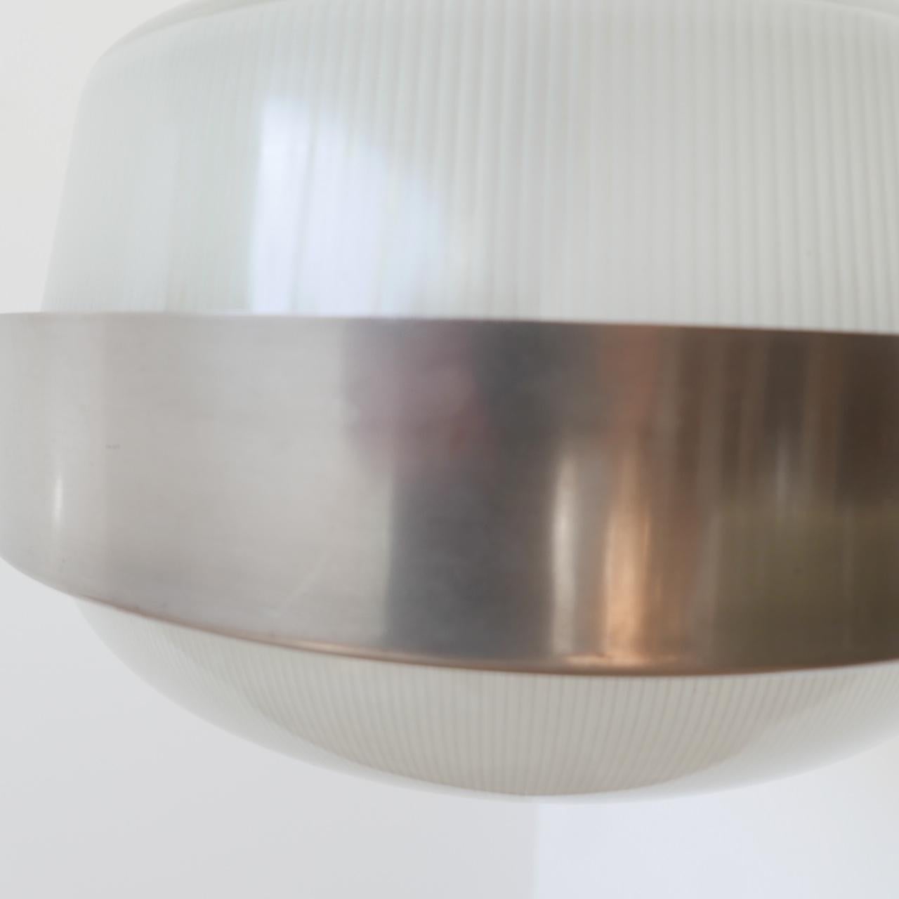 A Italian pendant light, attributed to Sergio Mazza for Artemide,

circa 1970s, Italy.

Two tone glass, with a nickel gallery and surround.

Re-wired and PAT tested.

Dimensions: approx. 40 diameter x 36 height (top of gallery) x 103 total