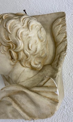Mid-century Italian plaster freeze of a young angel.