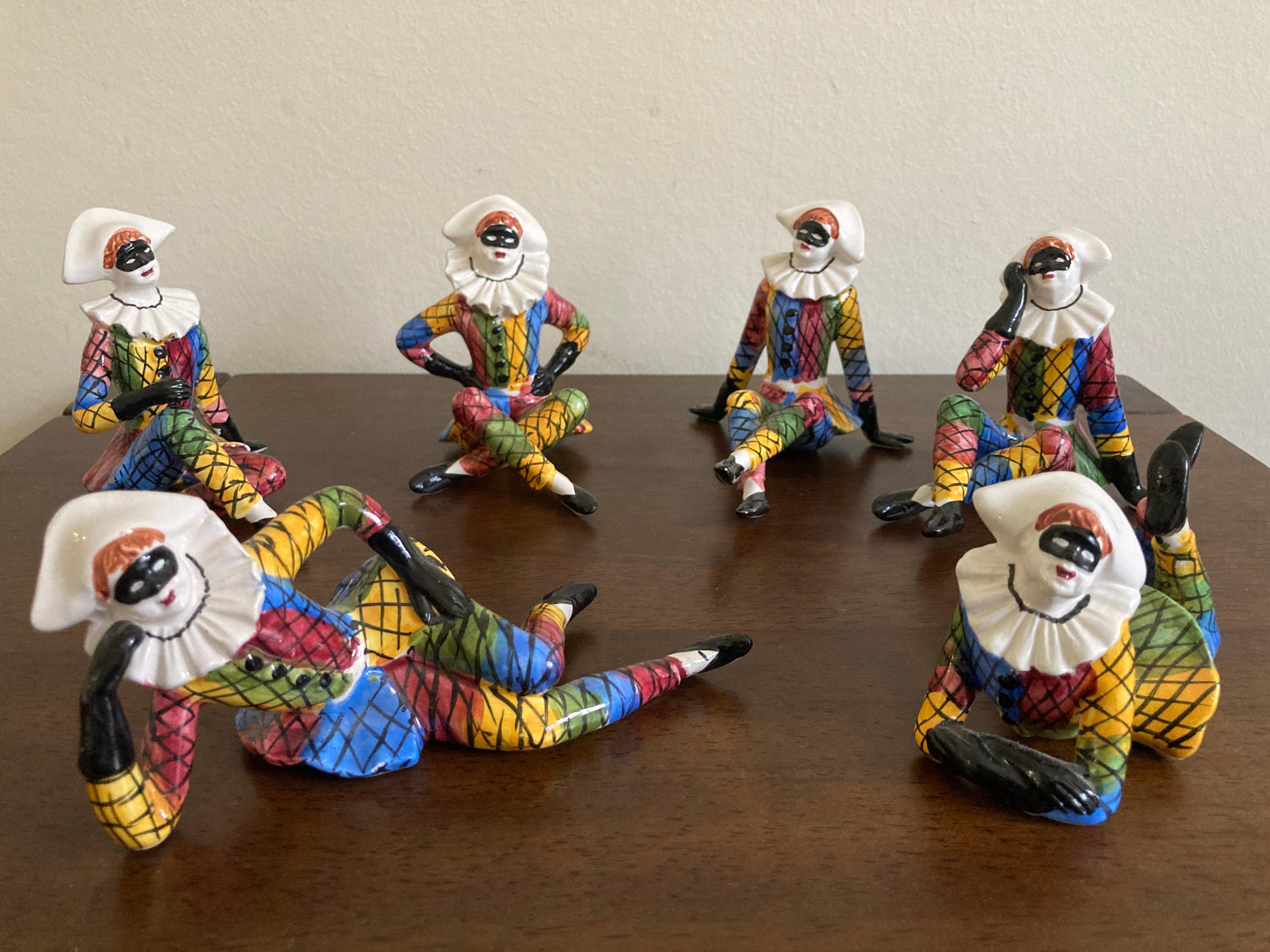 Set of Six Mid Century Italian Porcelain Harlequin Figurines , circa 1960, diamond-patterned costumes in multiple colours (red, blue, yellow, green, etc.), white ruffled collars, and black masks. Likely manufactured in Bassano region of Italy.  