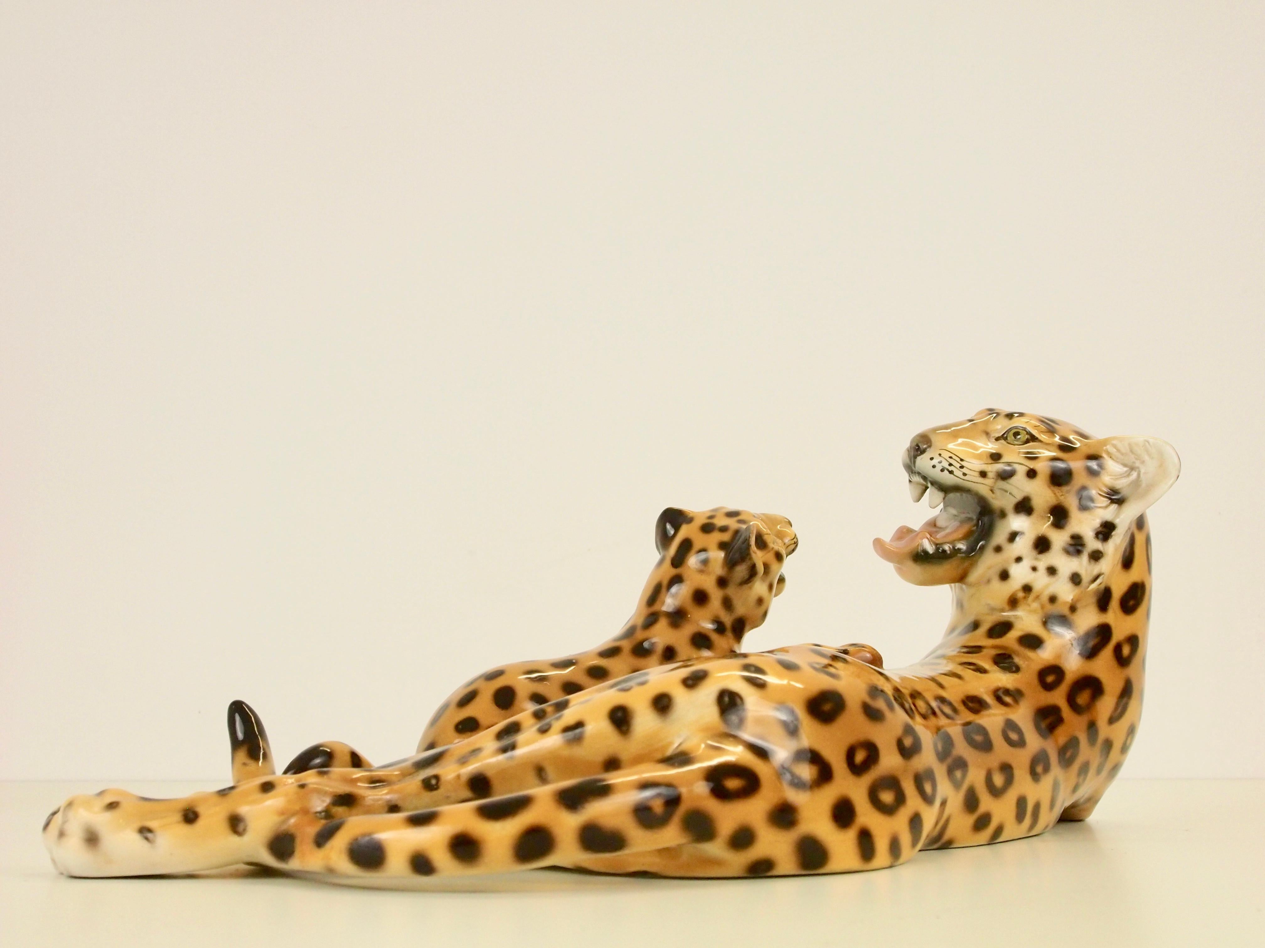 Vintage sublime fine hand painted porcelain statuette from Italy depicting a leopard mother playing with her cube.

This lovely statuette is not signed underneath with the manufactory stamp but just with a handwritten 