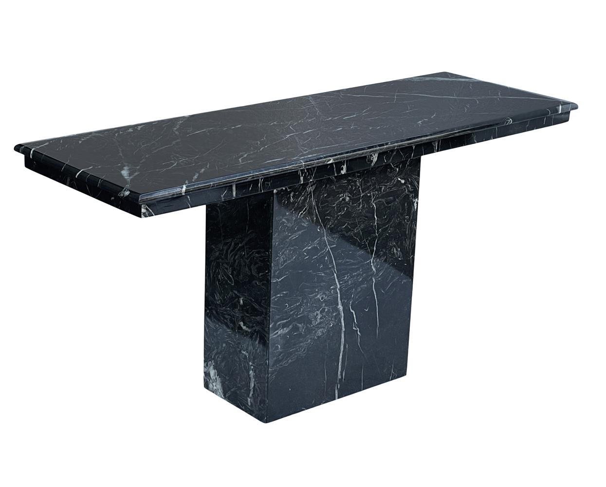 A sleek and modern console or sofa table from Italy circa 1980's. It features glossy black marble with veining. Very good condition.