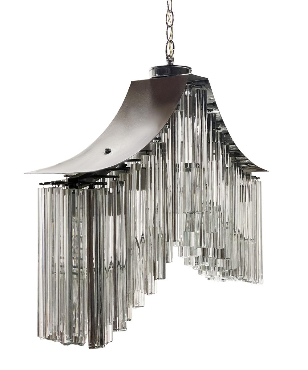 Stunning Venini midcentury Murano Triedri Chandelier. In a very desirable whale tail form. Features glass crystal prisms on polished steel frame. Takes 7 standard bulbs. Lead wire is 36 inches long, chain is 17 inches long. Tested and working.