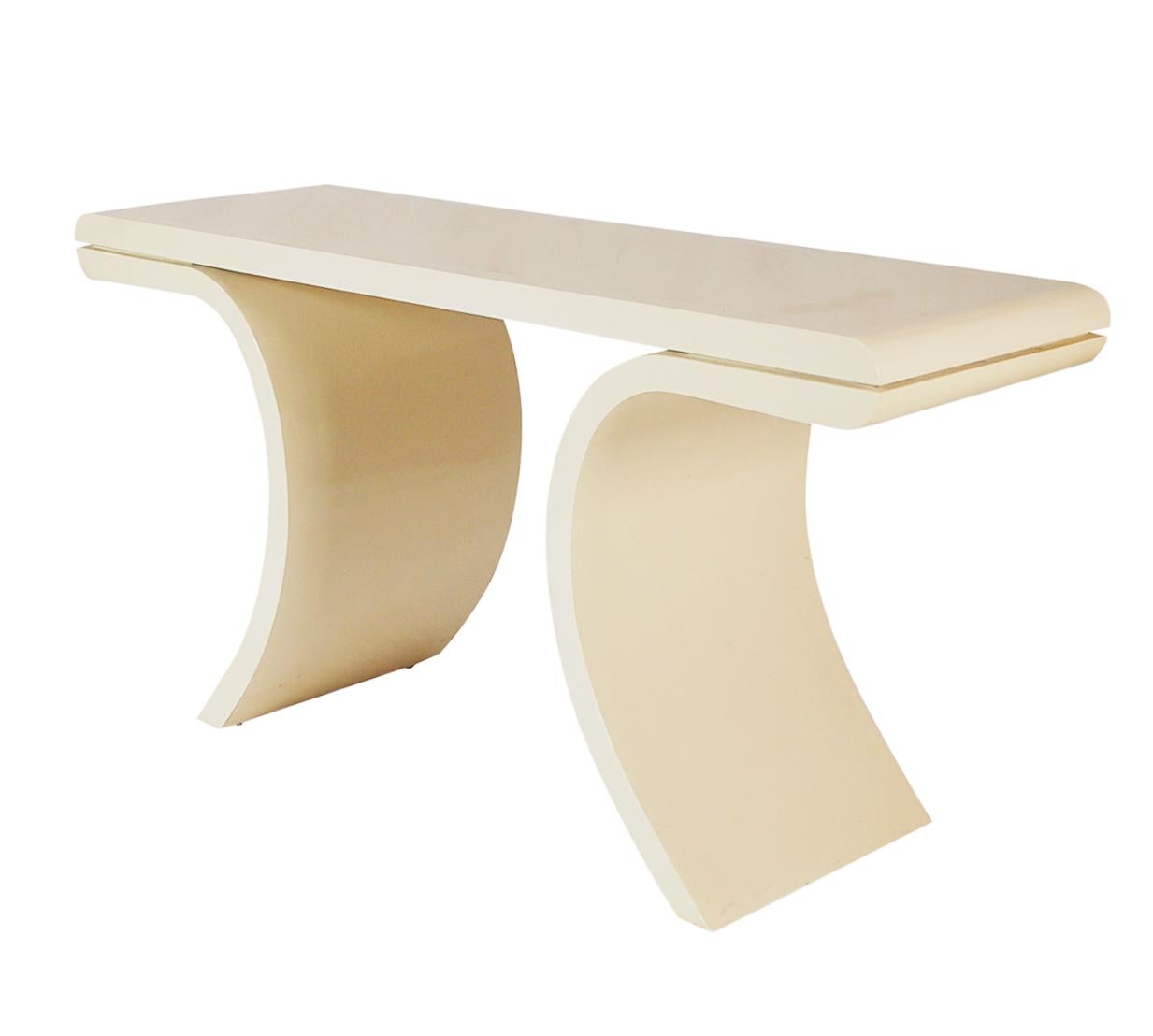 A curvy leg well made console from Italy, circa 1980s. It features heavy solid construction with gloss beige lacquer and brush stroke design top.