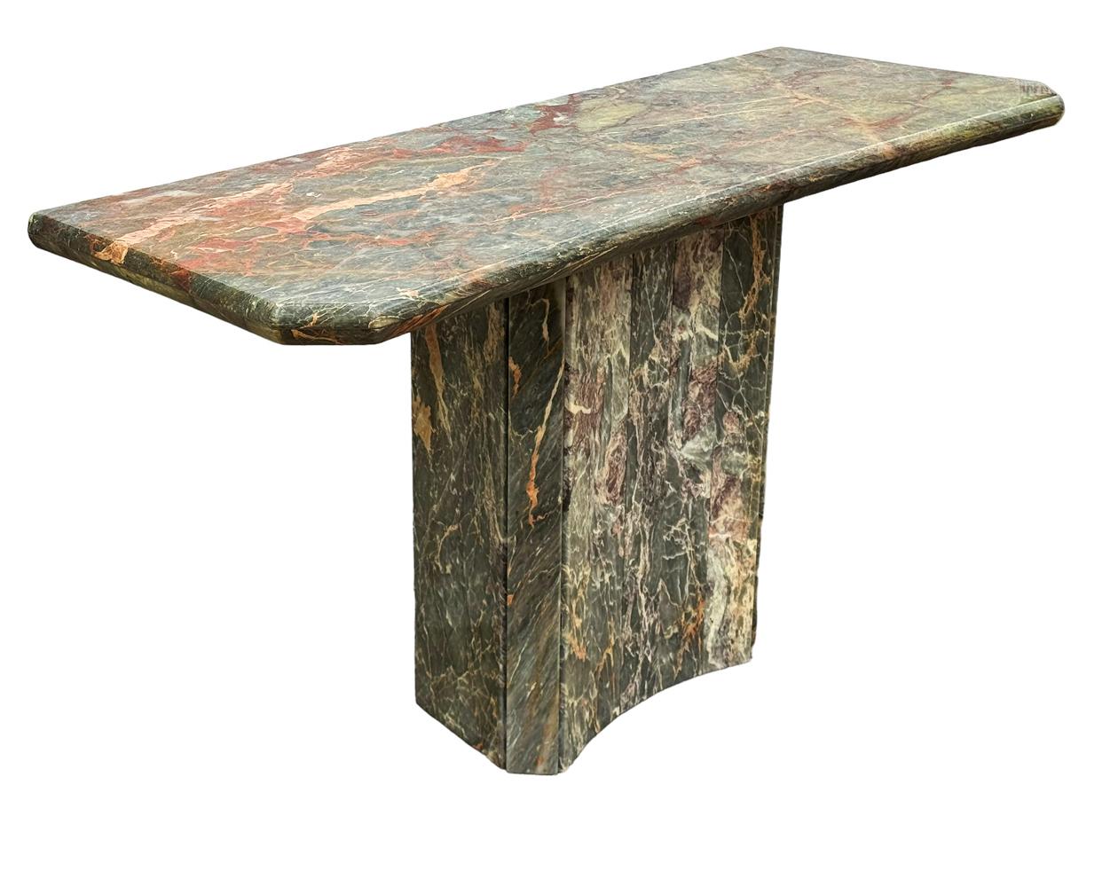 A stunning and simple modern console table from Italy circa 1970's. It consists of heavy  solid marble in an array of colors. Beautiful veining in marble & Top has bowed front. 