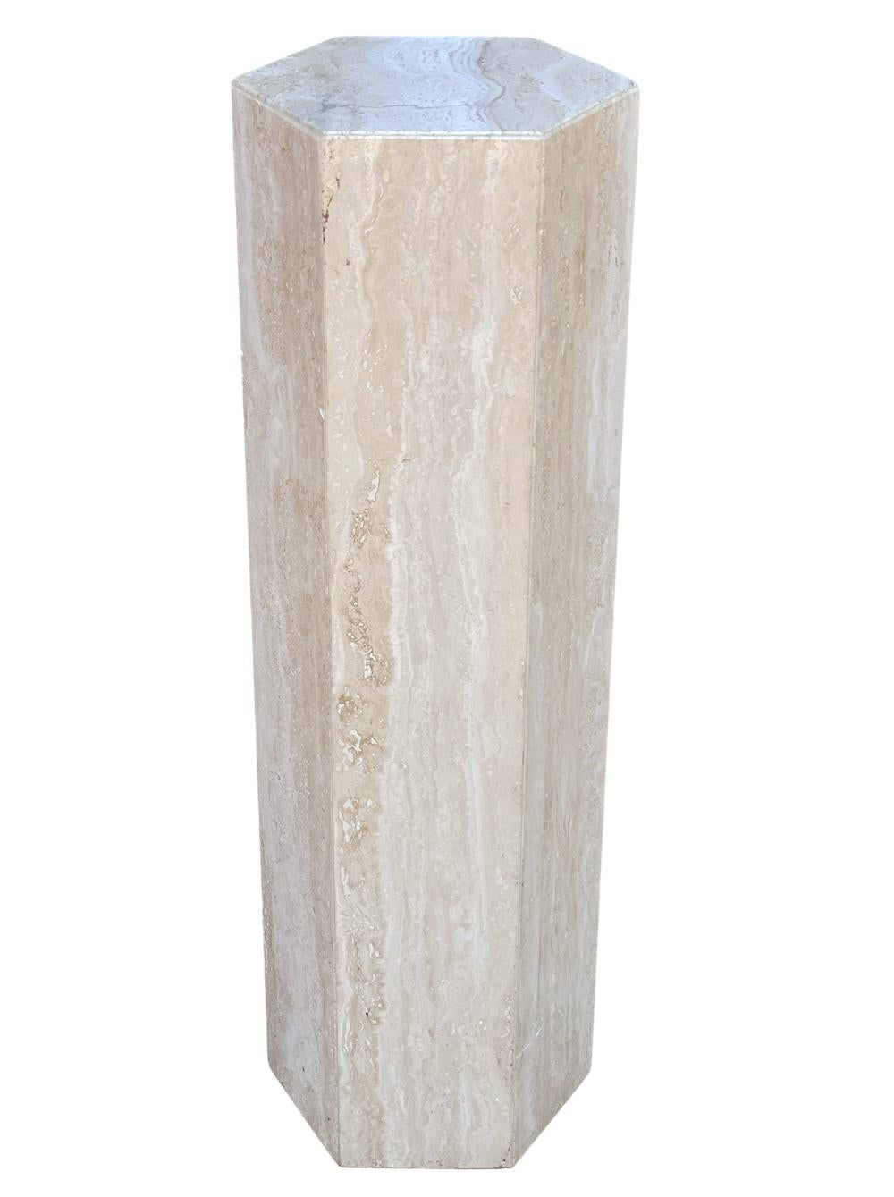 A tall and sleek looking pedestal from Italy, circa 1980s. It consists of thick solid travertine construction in a hexagonal form. Very good condition.