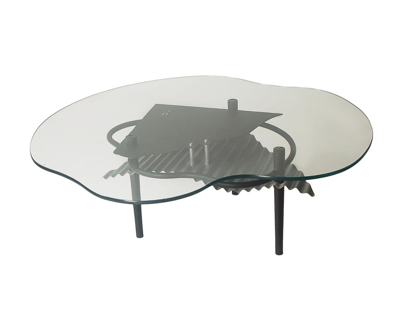 A super funky cocktail table design from the 1980's and made in Italy. It features all steel construction with thick clear glass top. Very good ready to use condition. 