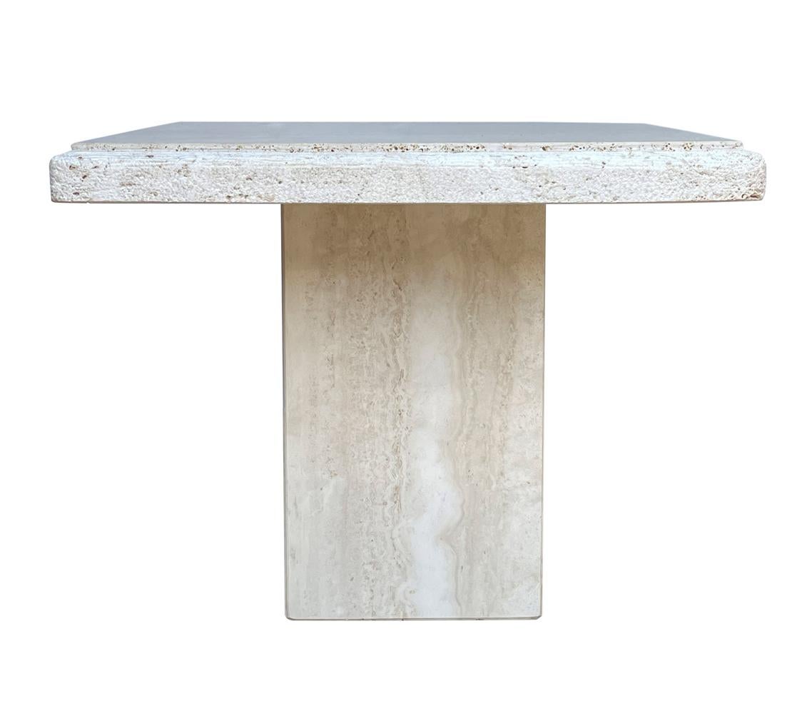 A beautiful organic travertine side table from Italy circa 1980's. It features heavy solid slab construction with textured raw edges.