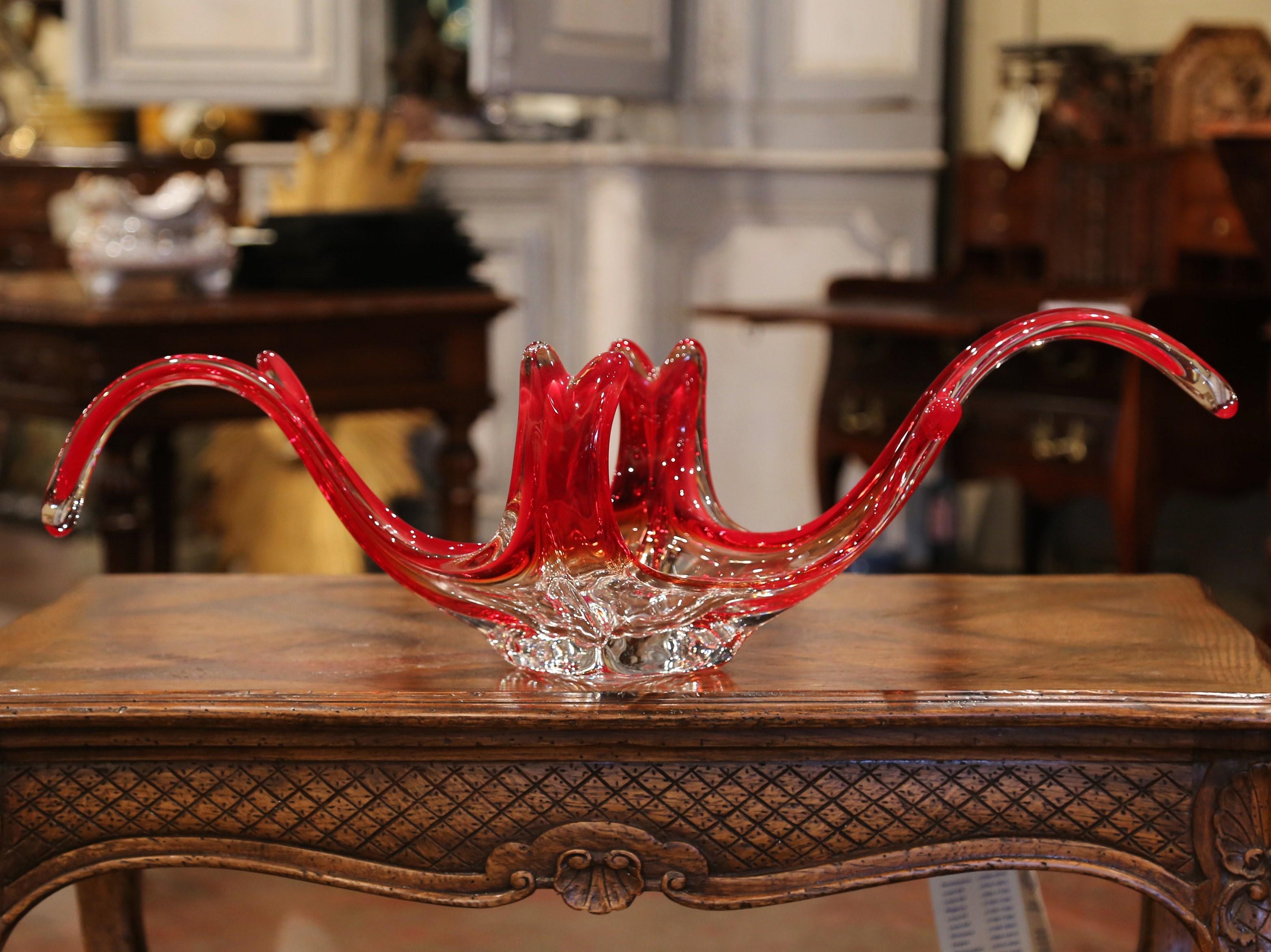 This elegant, hand blown glass console vase was crafted in Italy, circa 1950. The vintage piece from Murano has a clear color center and features a pulled feathered technique with an intricate curl design in red palette. The large traditional center