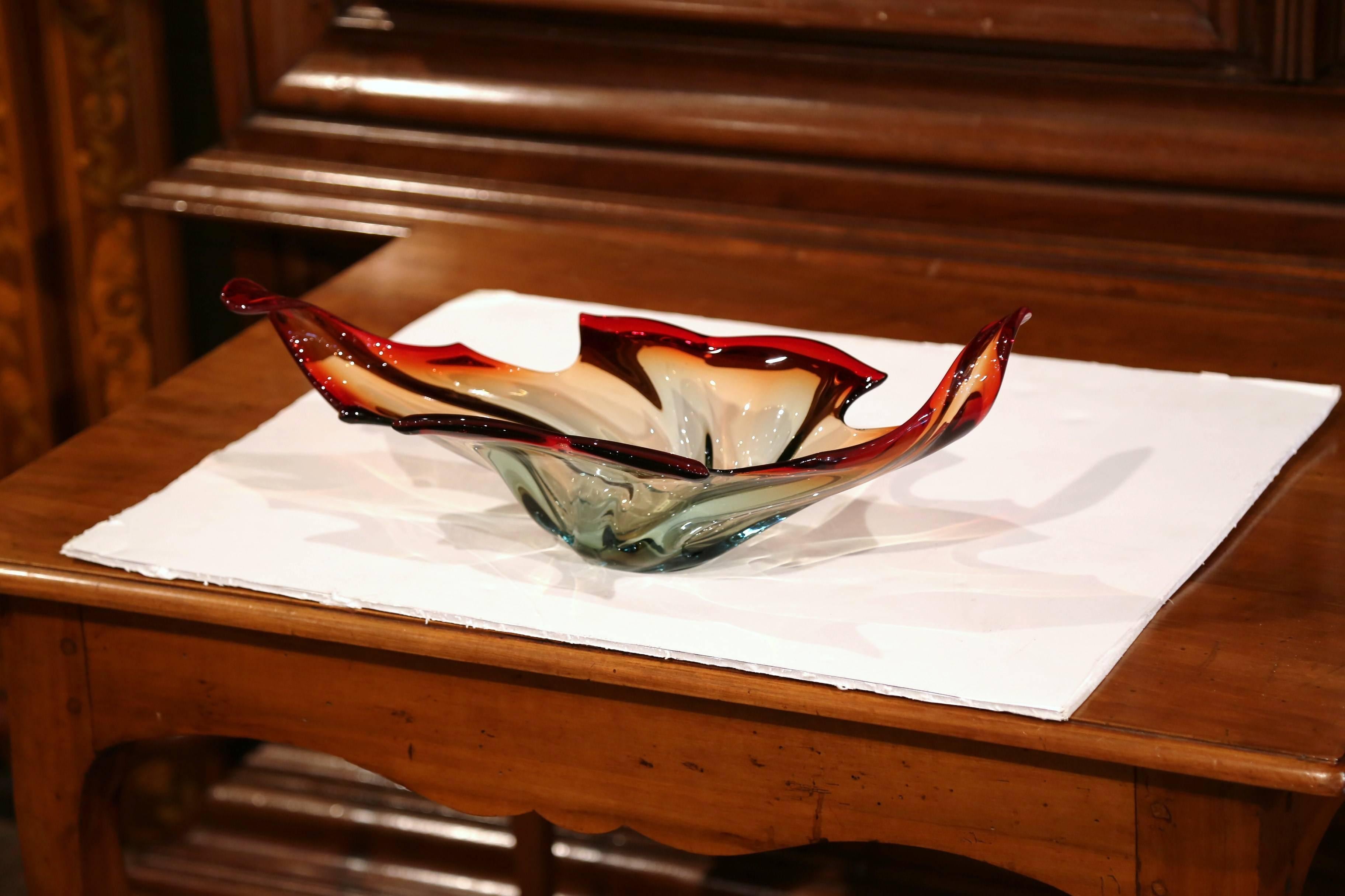 This elegant, handblown glass bowl was crafted in Italy, circa 1950. The vintage, red centre piece from Murano features a pulled feathered technique with an intricate curl design. The traditional large vase is in excellent condition with wonderful,