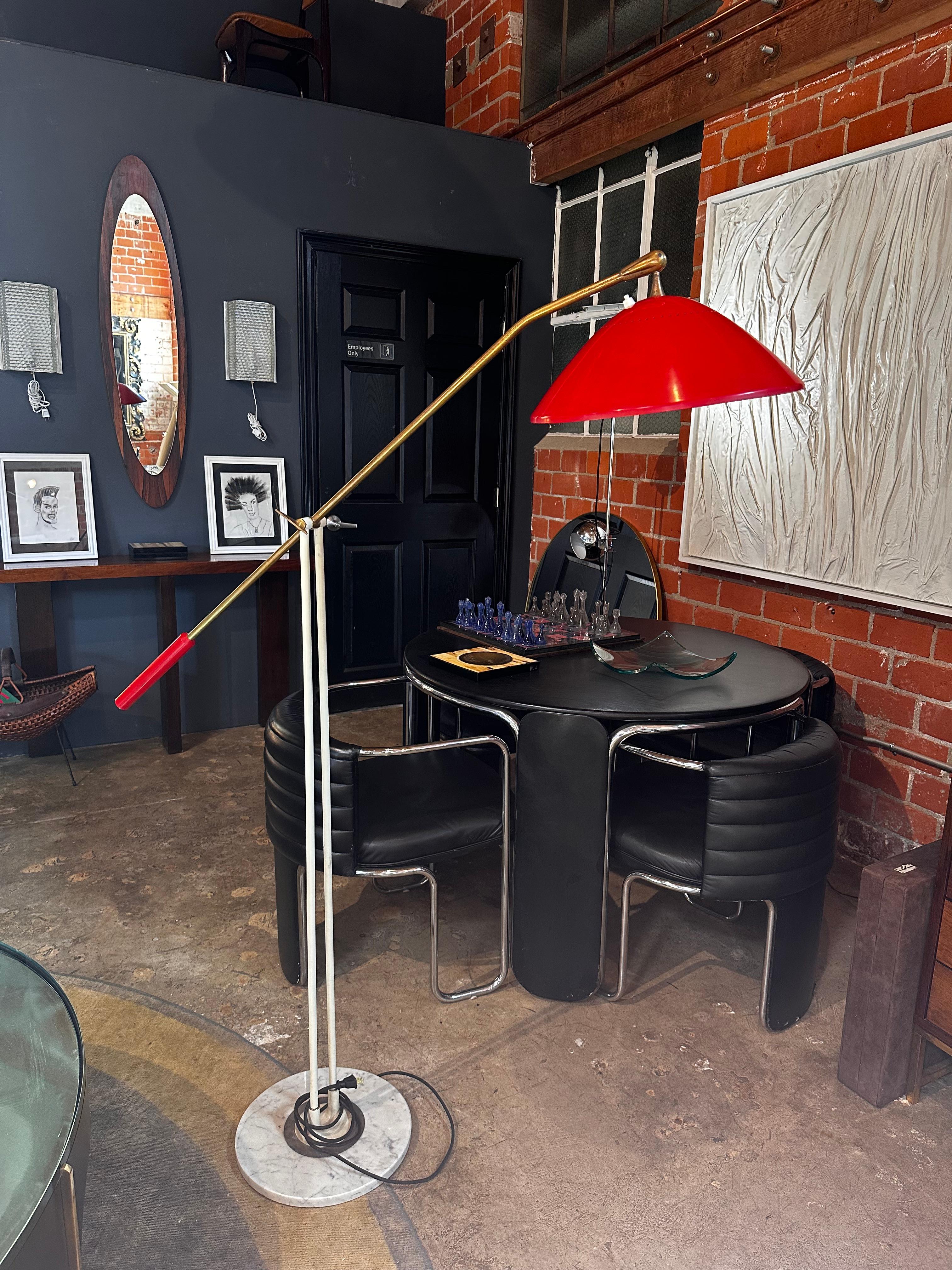 The Rare Floor Lamp by Stilnovo, crafted in Italy during the 1950s, is an exquisite piece that seamlessly blends mid-century design with functional elegance. Featuring a distinctive red shade, the lamp exudes a bold and captivating aesthetic. The