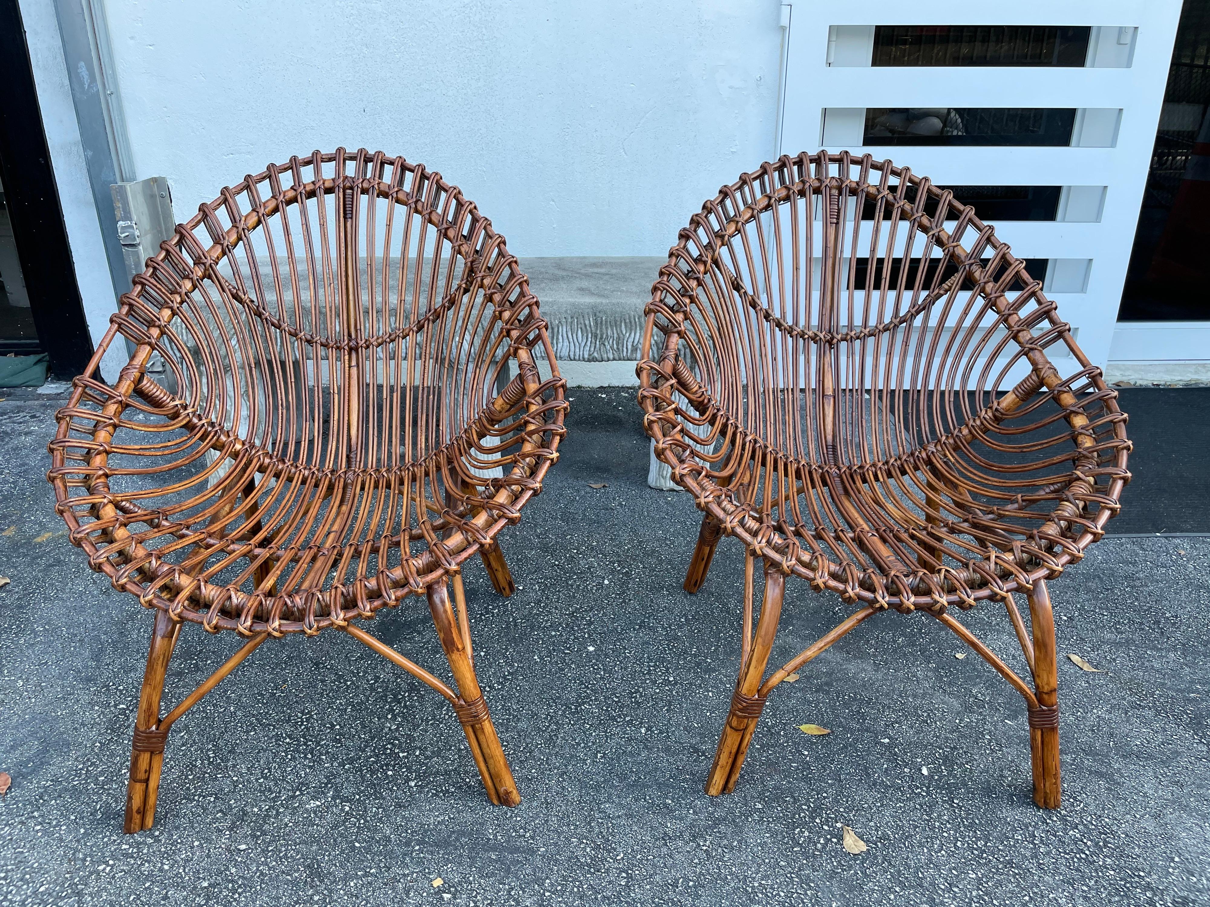 Bent bamboo and rattan for these wonderful scoop design chairs. These have some restoration work to return them to their beautiful original look. The sheepskins shown are only for sampling, they are not included. If you want to purchase them, we can