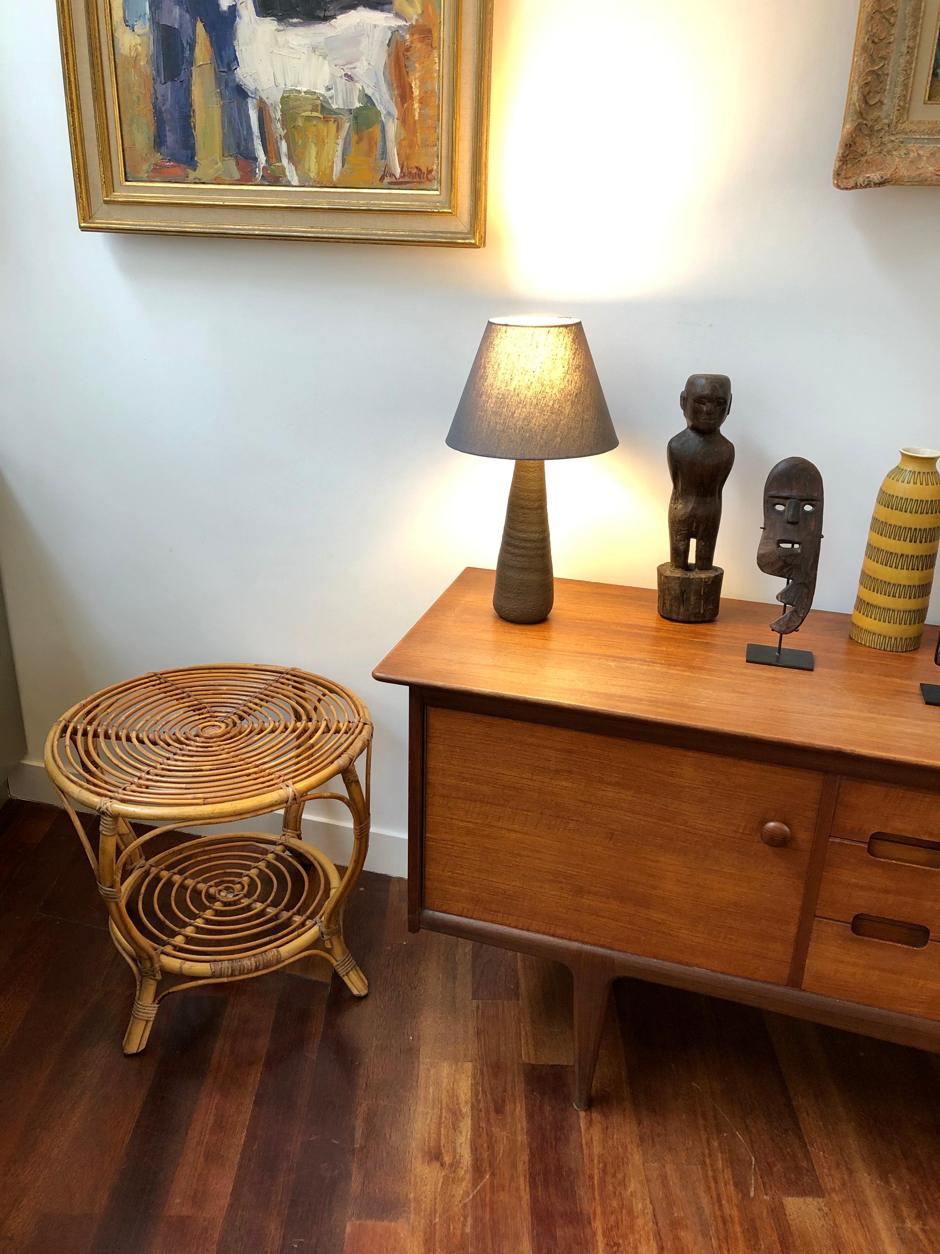 Italian rattan coffee / end table (circa 1960s). A very stylish piece with slews of character and charm. A rare rounded shape with two horizontal surfaces for storage or display set this characterful table apart from the others. The smart-looking