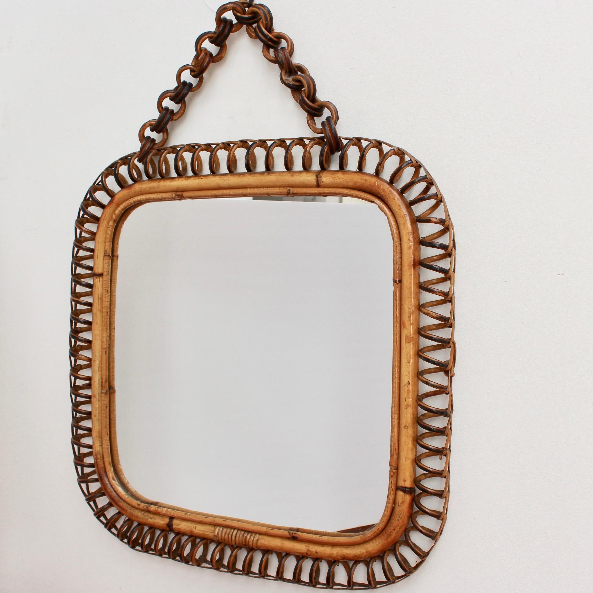 Midcentury Italian rattan square mirror with hanging chain (circa 1960s). Rarely available, this square shaped rattan mirror is a rare find. The square frame is decorated on the surround with coiled rattan reminiscent of old telephone cord. The