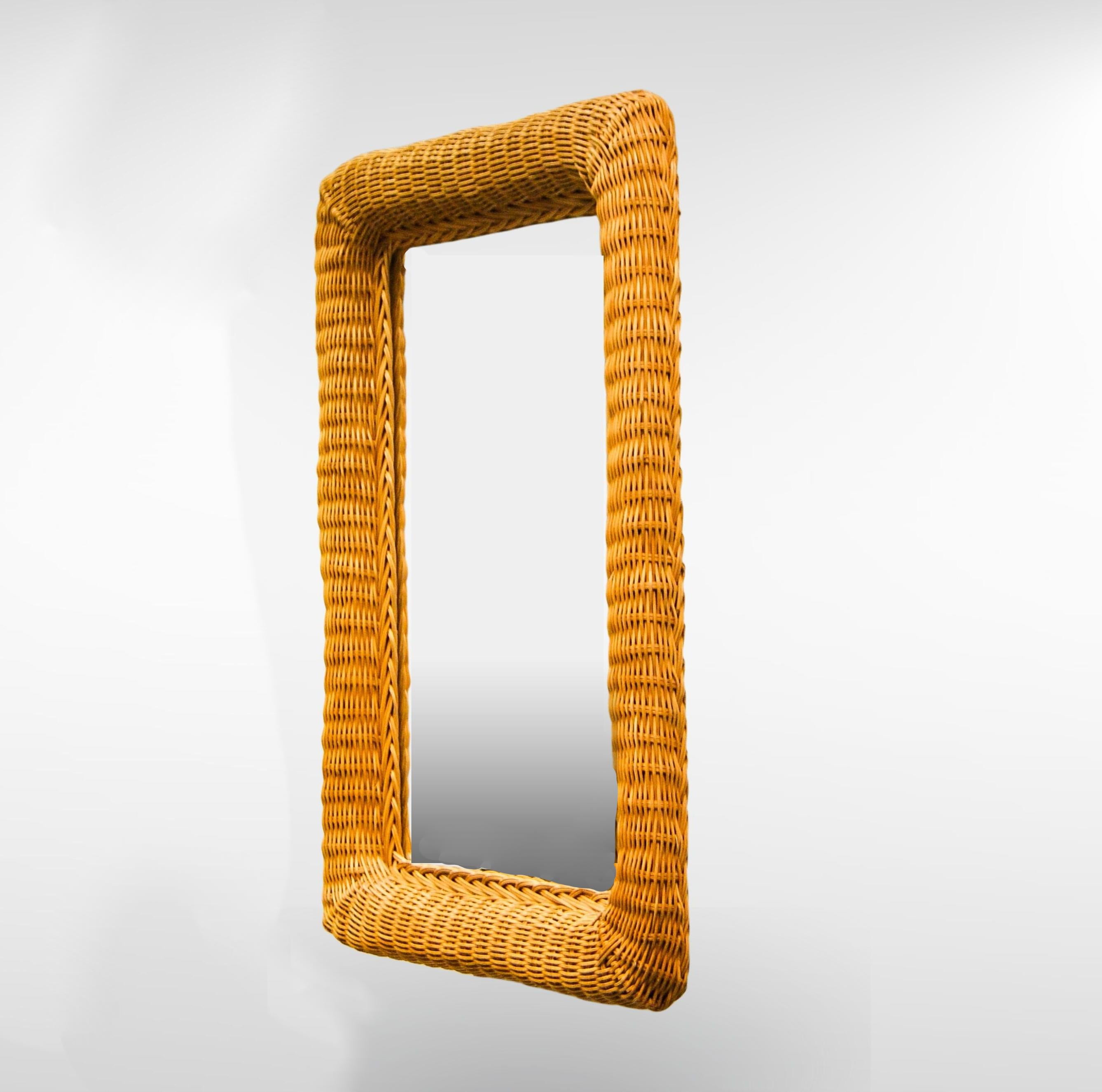 Gorgeous 1960s Italian rattan wall hanging mirror.
The mirror has wide woven rattan frame and can be hung horizontally or vertically.
Highly decorative large sized mirror.

In very good vintage condition.
Shows small signs consistent with