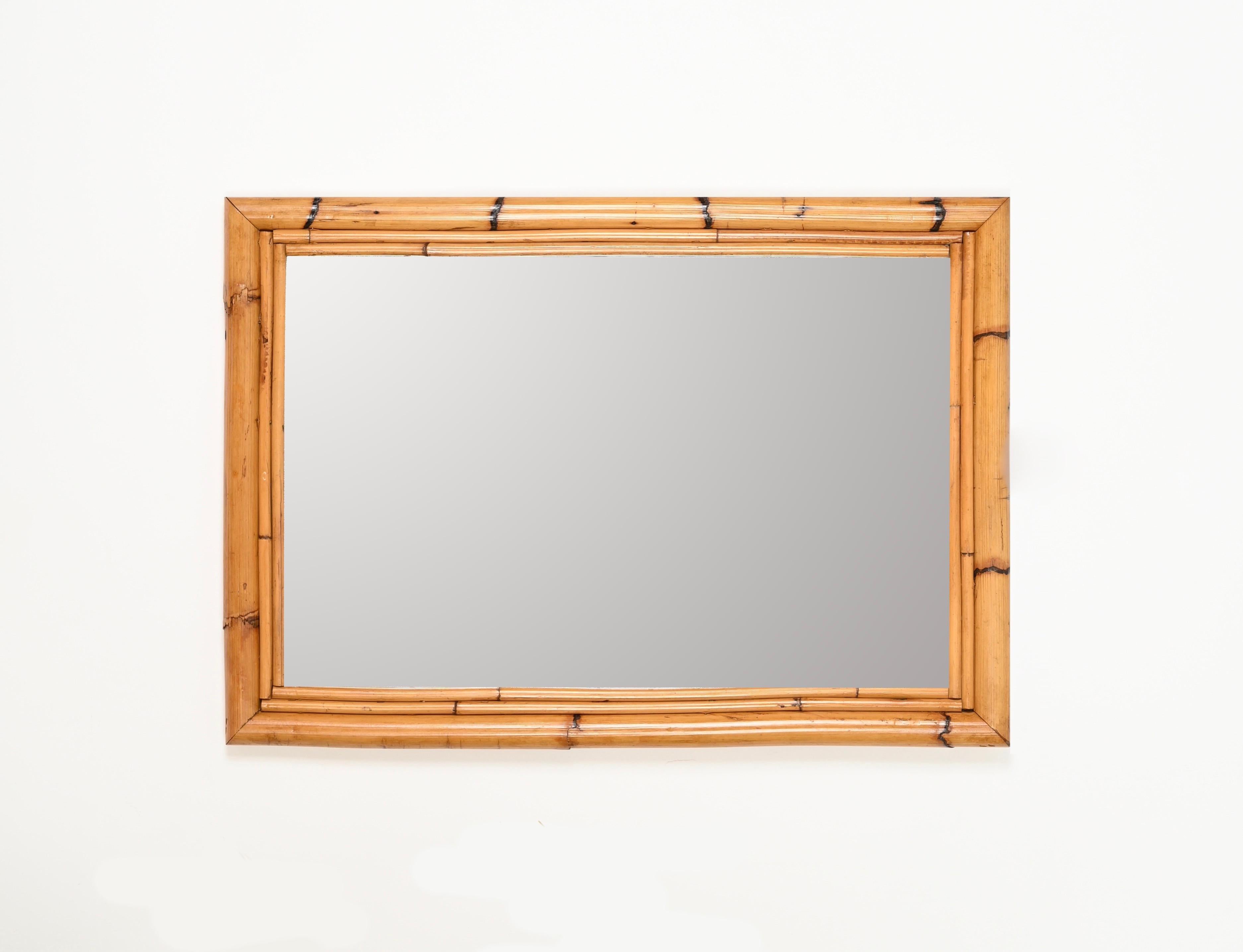 Gorgeous Mid-Century rectangular mirror with a triple frame in bamboo and rattan. This stunning French Riviera style mirror was hand-made in Italy during the 1970s.

In fantastic conditions and with a delightful honey color. This organic mirror has