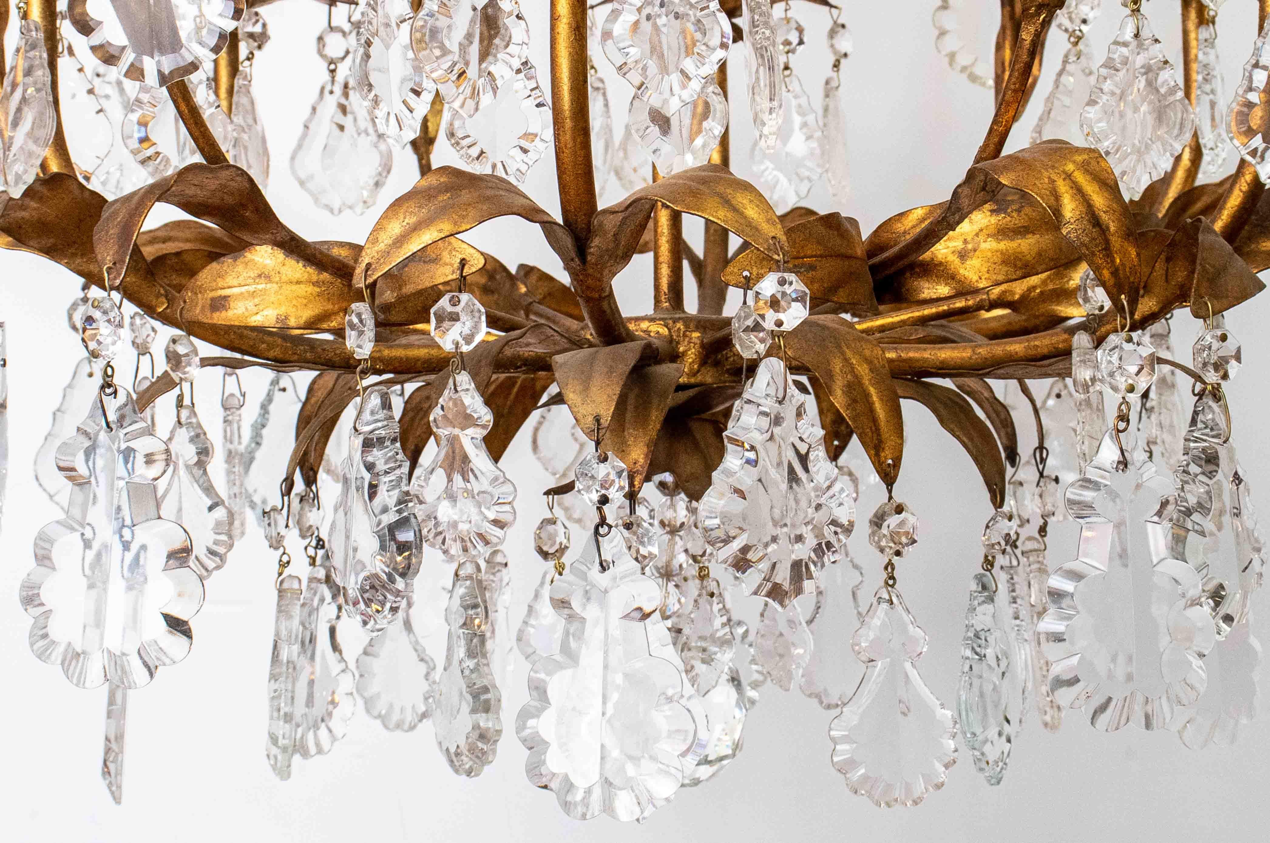 Mid-century Italian Hollywood Regency style Florentine bird cage chandelier. Made in Italy in the 1950's. The chandelier comes with graduated crystal throughout.