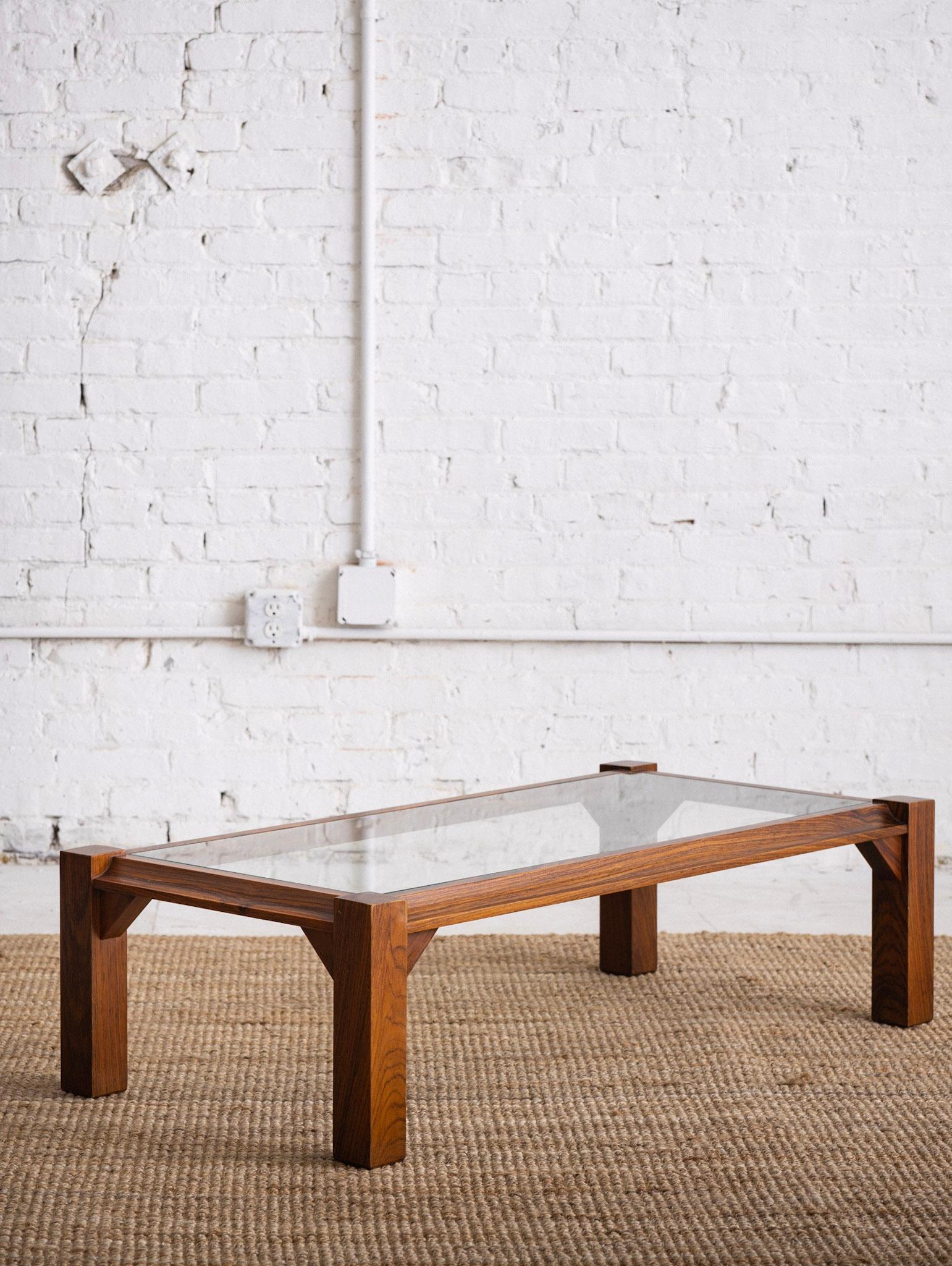 Mid century Italian coffee table. Solid rosewood frame with glass top. Rich wood grain detail. Sourced outside of Florence, Italy.