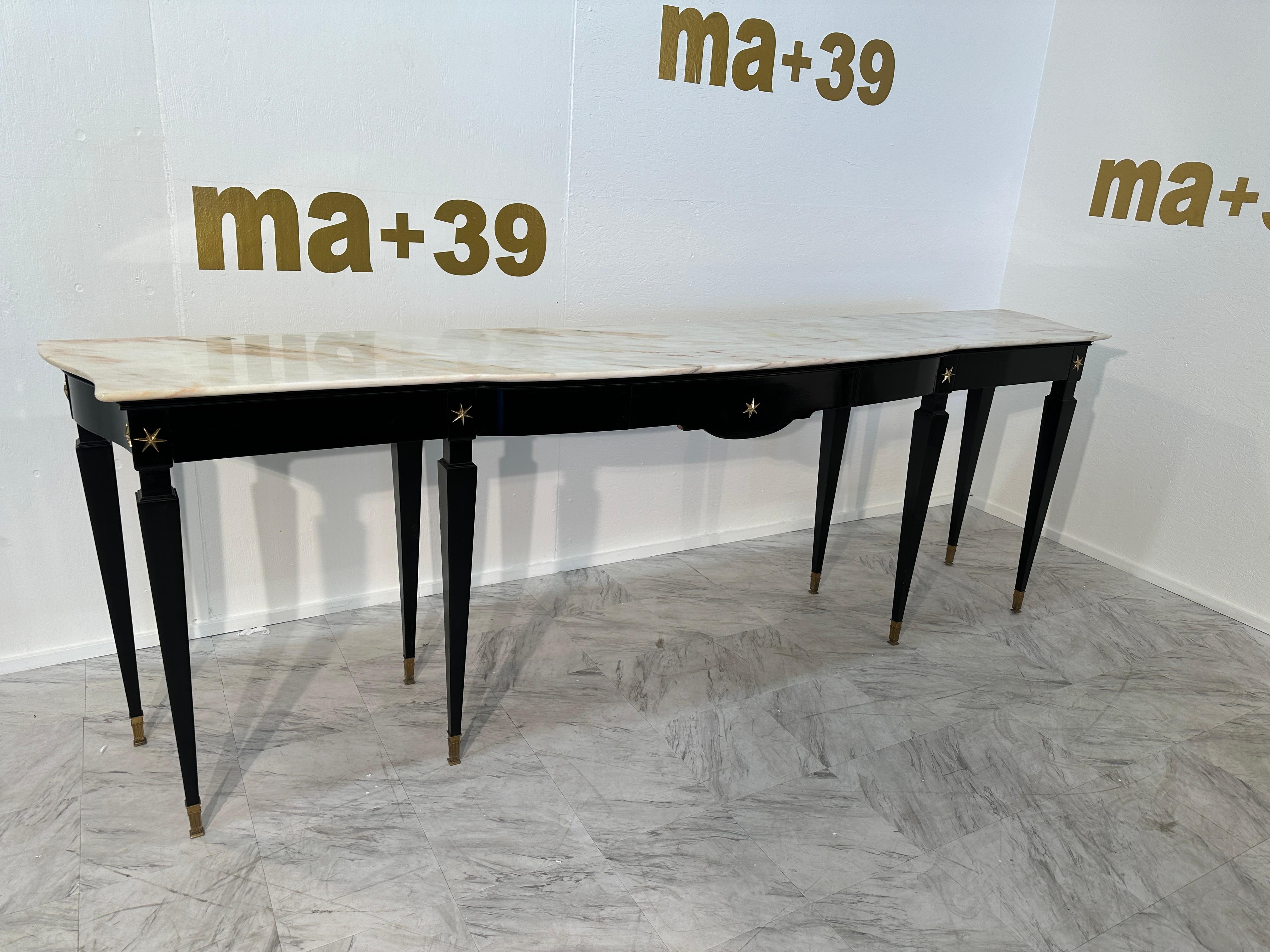 The Mid Century Italian Rosewood and Marble Console by Paolo Buffa, crafted in the 1950s, is an exquisite piece of furniture that exudes timeless elegance. Designed by the renowned Italian architect Paolo Buffa, this console features a lustrous