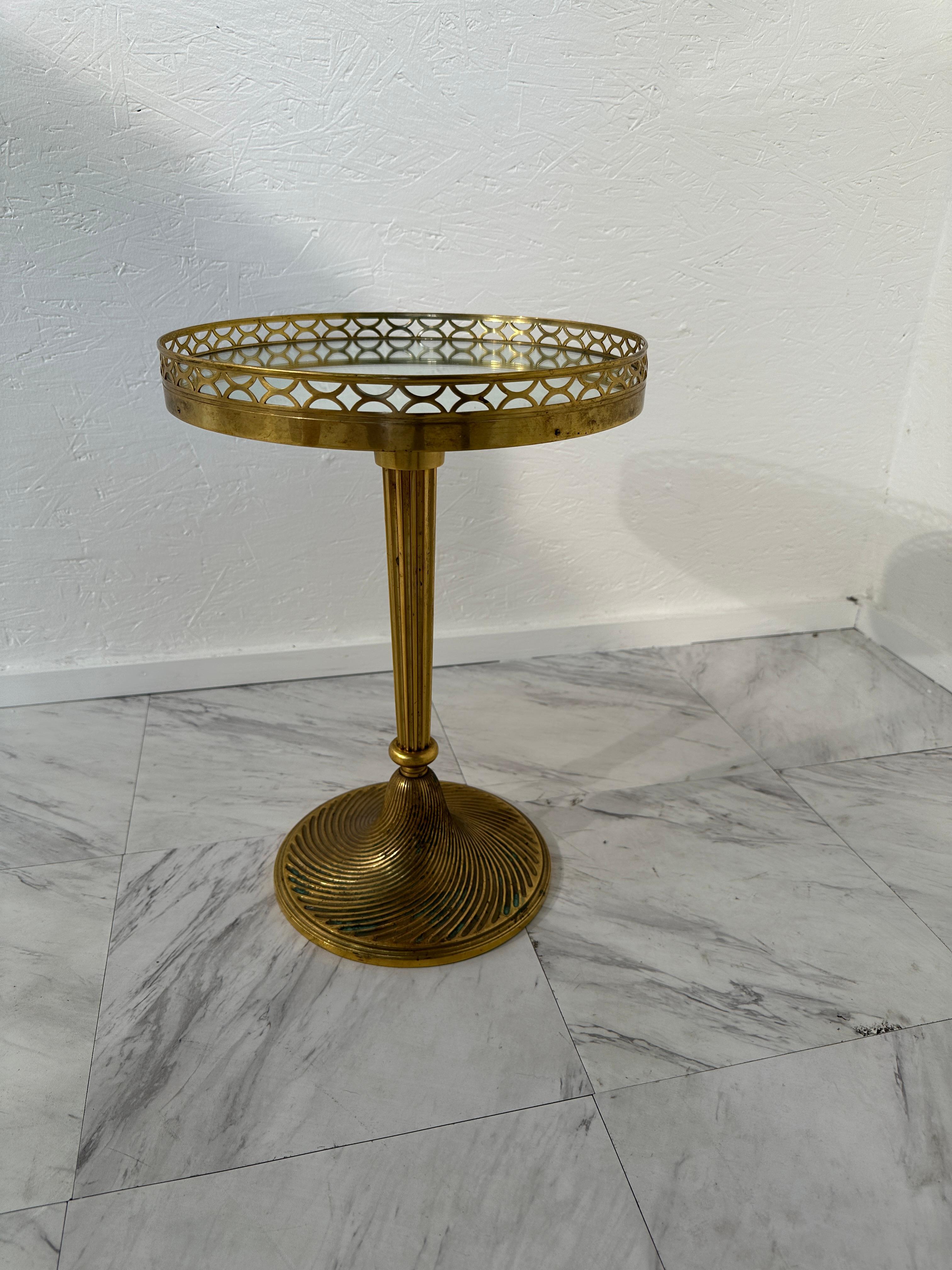 The Mid Century Italian Round Brass Side Table from the 1960s is a stylish and iconic piece that embodies the design ethos of the mid-century modern era. Crafted with a round top, this side table features a lustrous brass finish, providing a touch