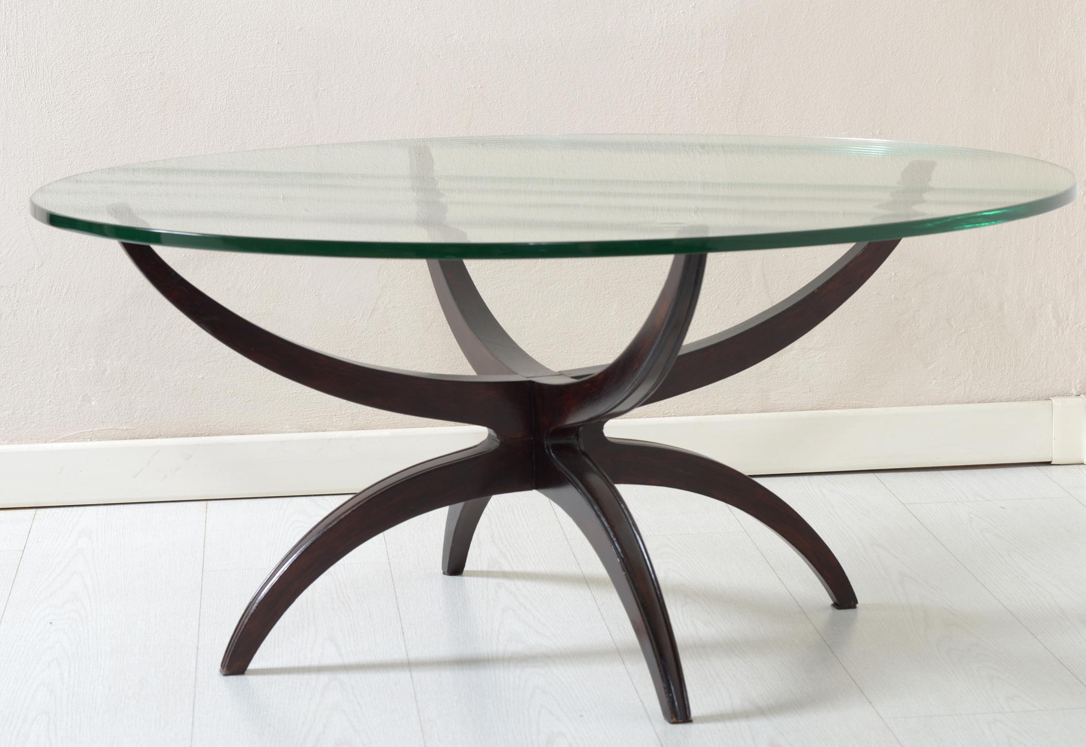 Mid-Century Modern Italian round coffee table, black lacquered solid wood for the light structure with curved lines and thick round glass.
 