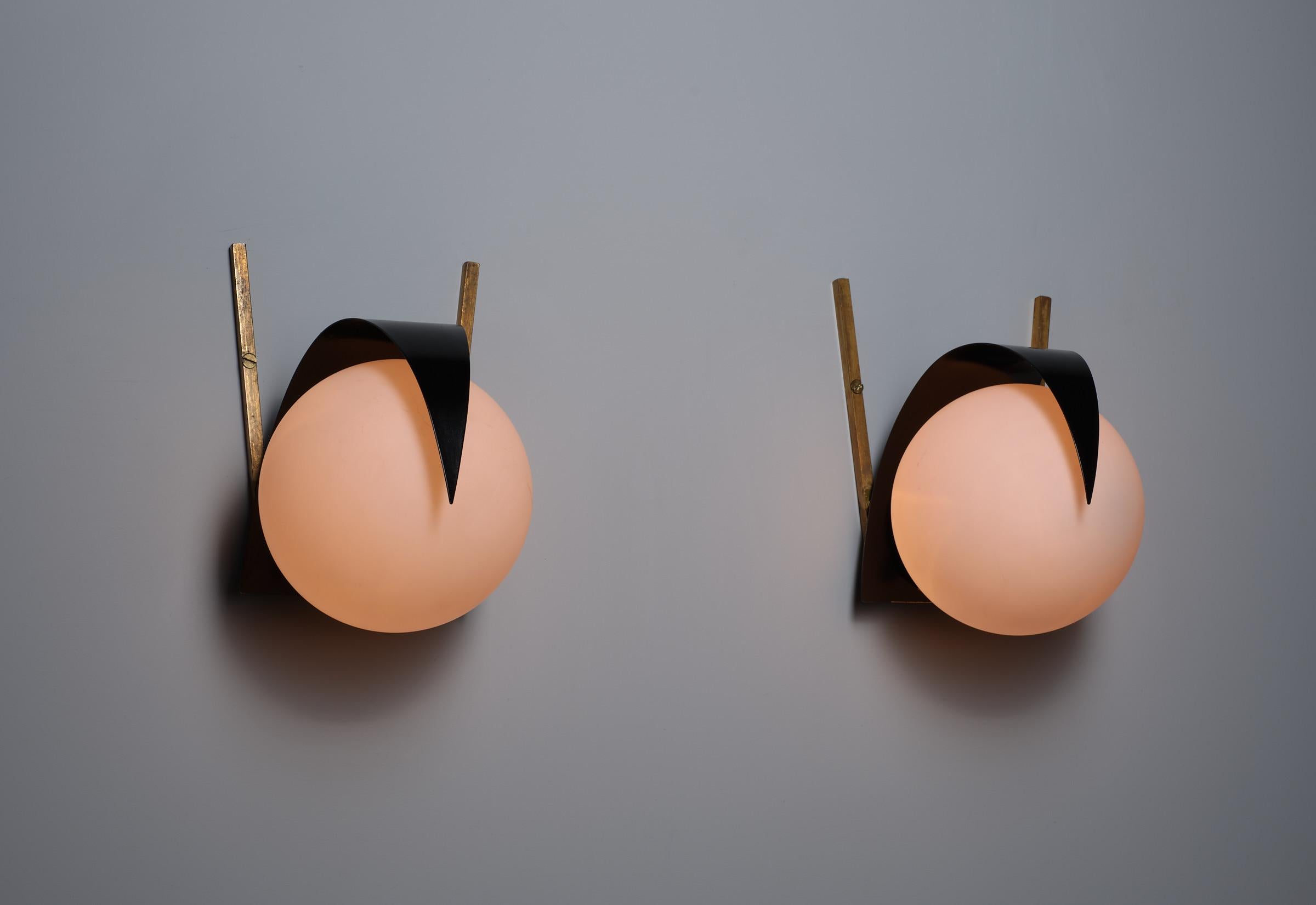 Presenting a distinguished pair of Italian mid-century wall sconces, attributed to the esteemed design lineage of STILNOVO. These lamps exemplify the sleek, geometric aesthetics of the 1950s and 1960s, making them a superb addition to any collection