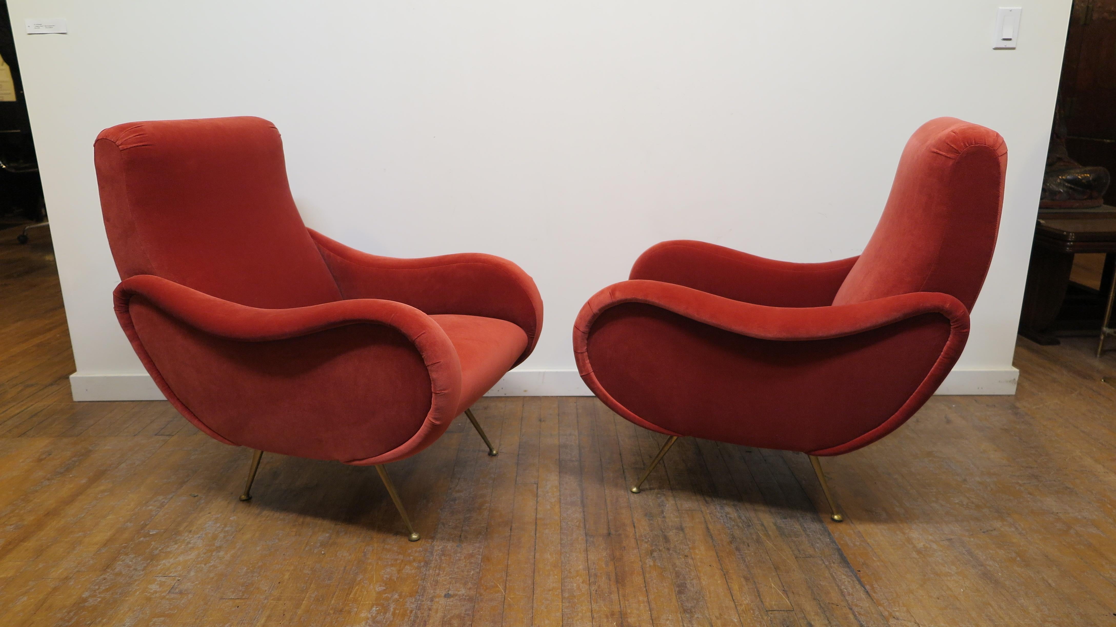 Pair of Italian sculpted lounge chairs in the style of Marco Zanuso.  Zanuso style Italian Sculpted lounge chairs with solid brass legs upholstered in Nobilis Pairs Velvet.   Contoured seat provides great support and position.  Beautifully sculpted