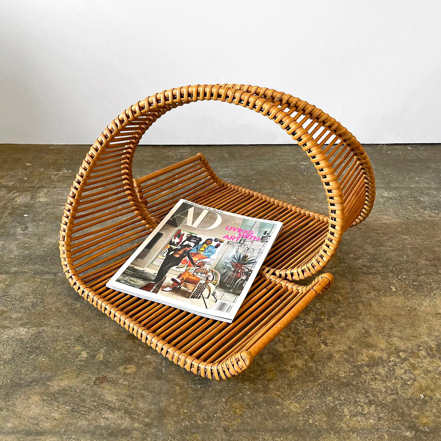Italian rattan magazine holder 
This dramatic statement piece is an artisanal masterpiece 
Beautifully sculpted hand woven rattan reeds are formed into a transcendent wave pattern 
Each side holds two full size magazine storage spaces 
Natural color