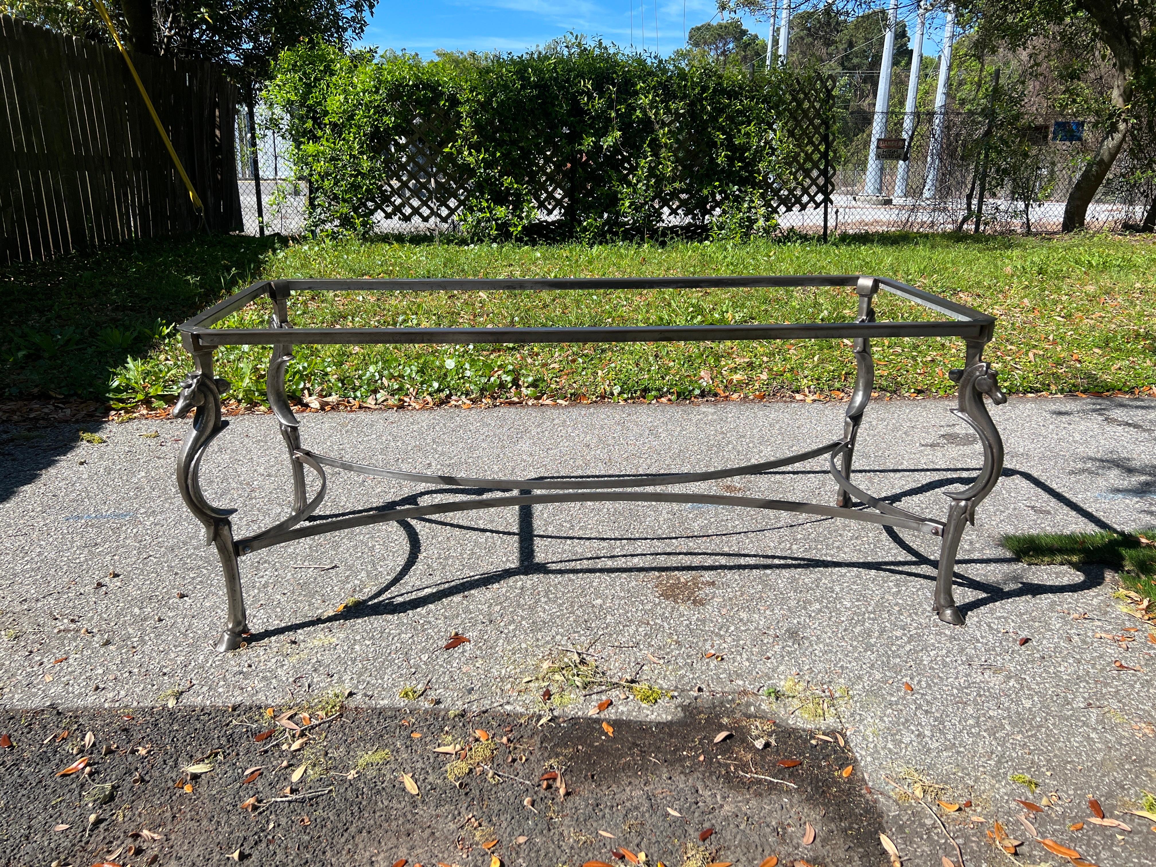 Italian, circa 1950. Attributed to the workshop of Maison Jansen or Maison Ramsey. 

A mid century dining table constructed in solid steel. This heavy and fine quality piece featured a steel frame, a cross hatch detail curved x stretcher, four horse