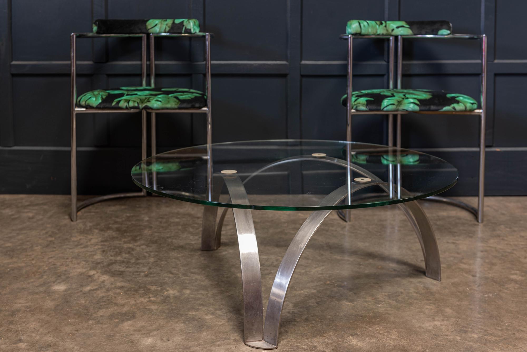 Midcentury Italian sculptural coffee table,
circa 1950s-1960s.

Beautiful sculptural formed stainless steel base with a toughened 10mm thick glass top.

Measures: Diameter 90 cm, height 33 cm.