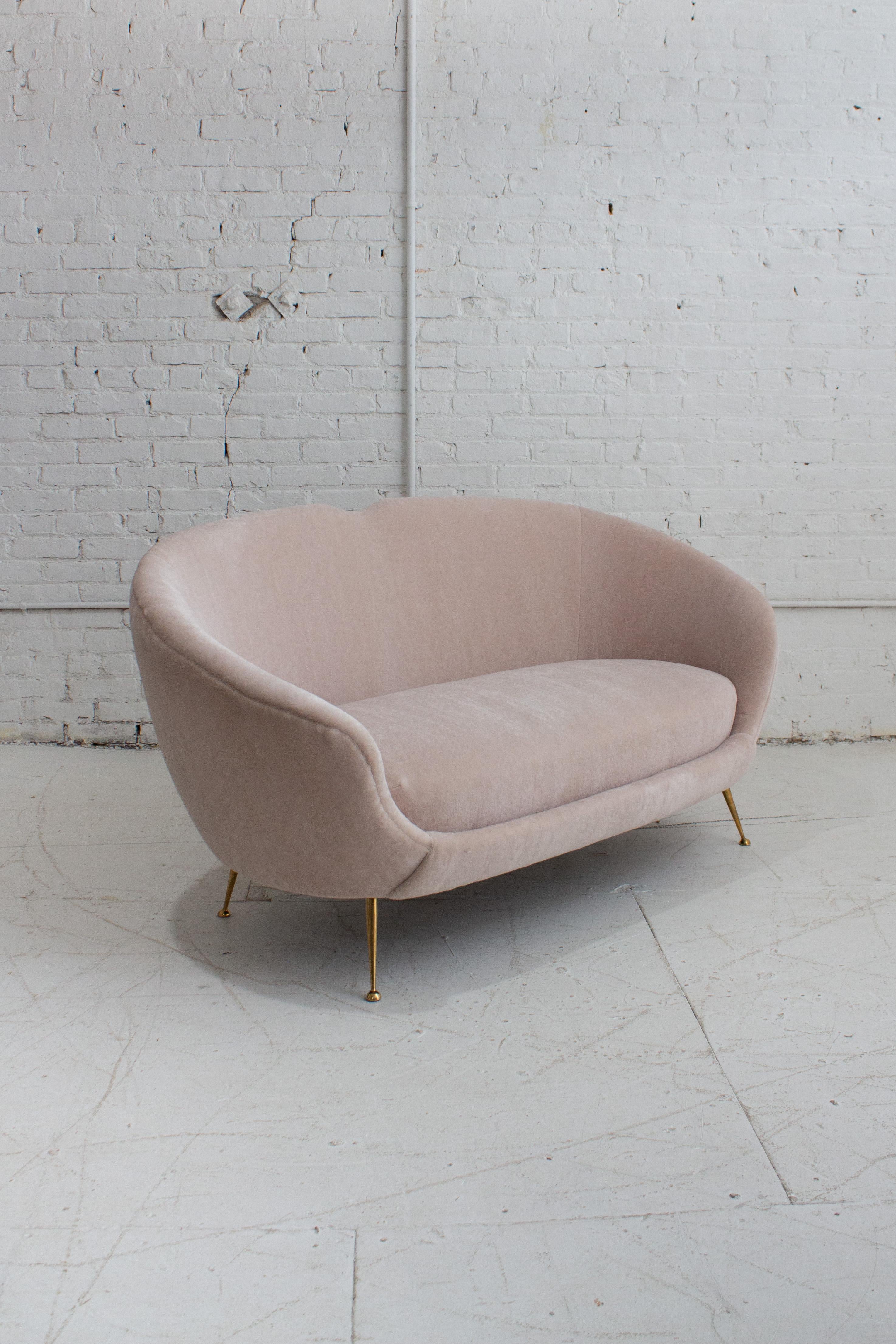 A 1950's Italian settee or loveseat attributed to ISA Bergamo. Newly reupholstered in a high quality luxury mohair. A soft high pile fabric with a color that reads as both a creamy neutral and pale blush depending on the light. Rounded silhouette