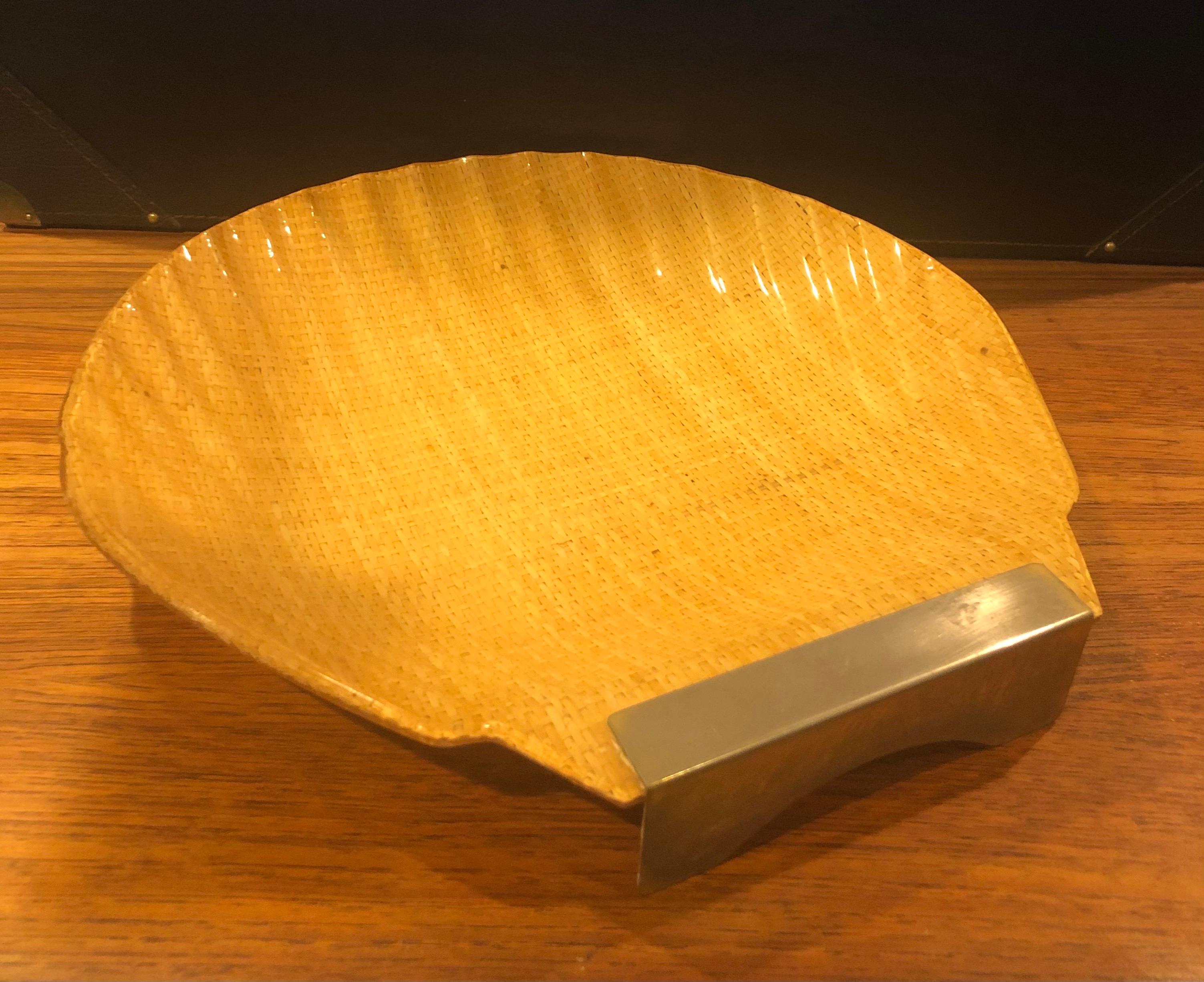Midcentury Italian shell shaped lacquered rattan and brass platter, circa 1950s. The piece measures 15.75