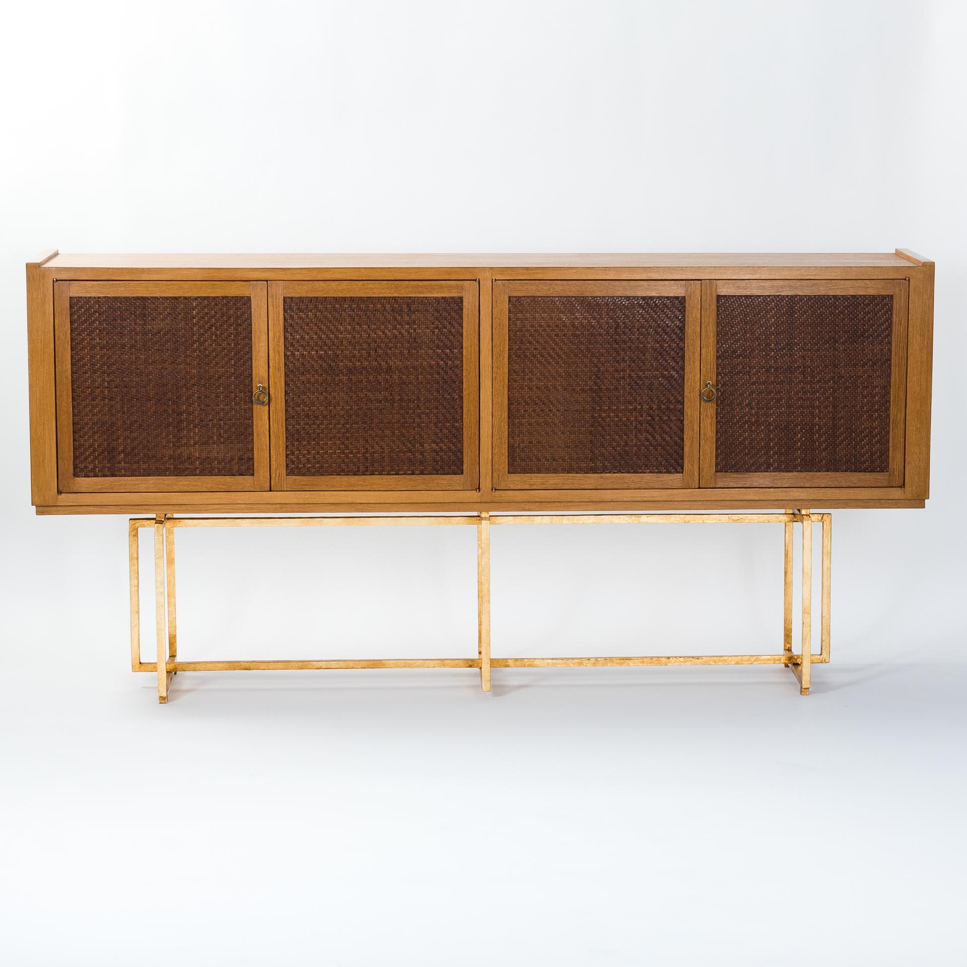 Straight-lined Italian sideboard from the 1960s on a geometric metal base.
The body is veneered with oak, the panels of the front doors are designed with braided fine leather straps - a beautiful ajouré work.
The base is made of rectangular iron