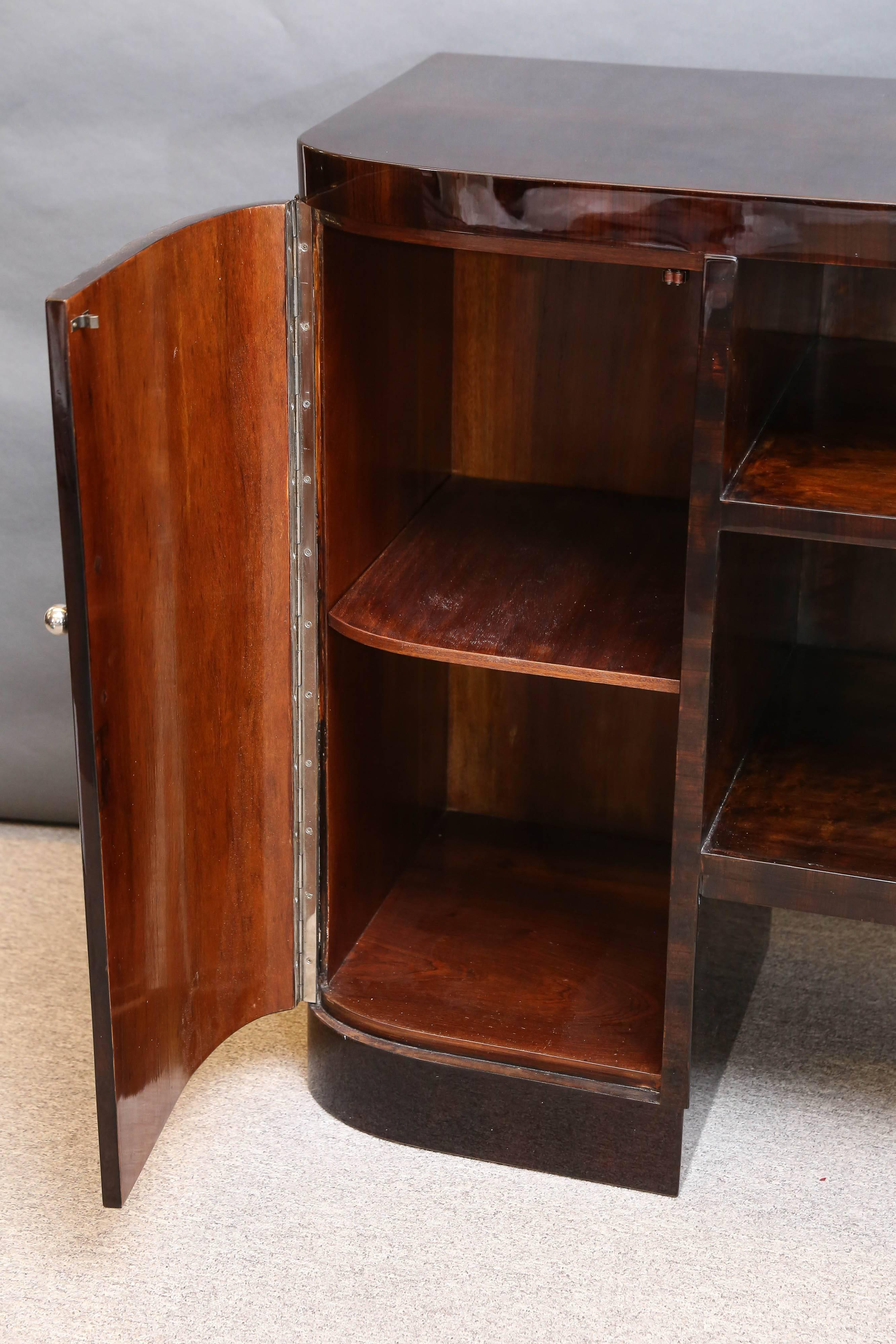 Beautiful sideboard has four spacious drawers on the right side and one big drawer with two shelves on the left side. Between them there are two wide shelves that are connecting right and left sides. Each of the drawers has a chrome handle.