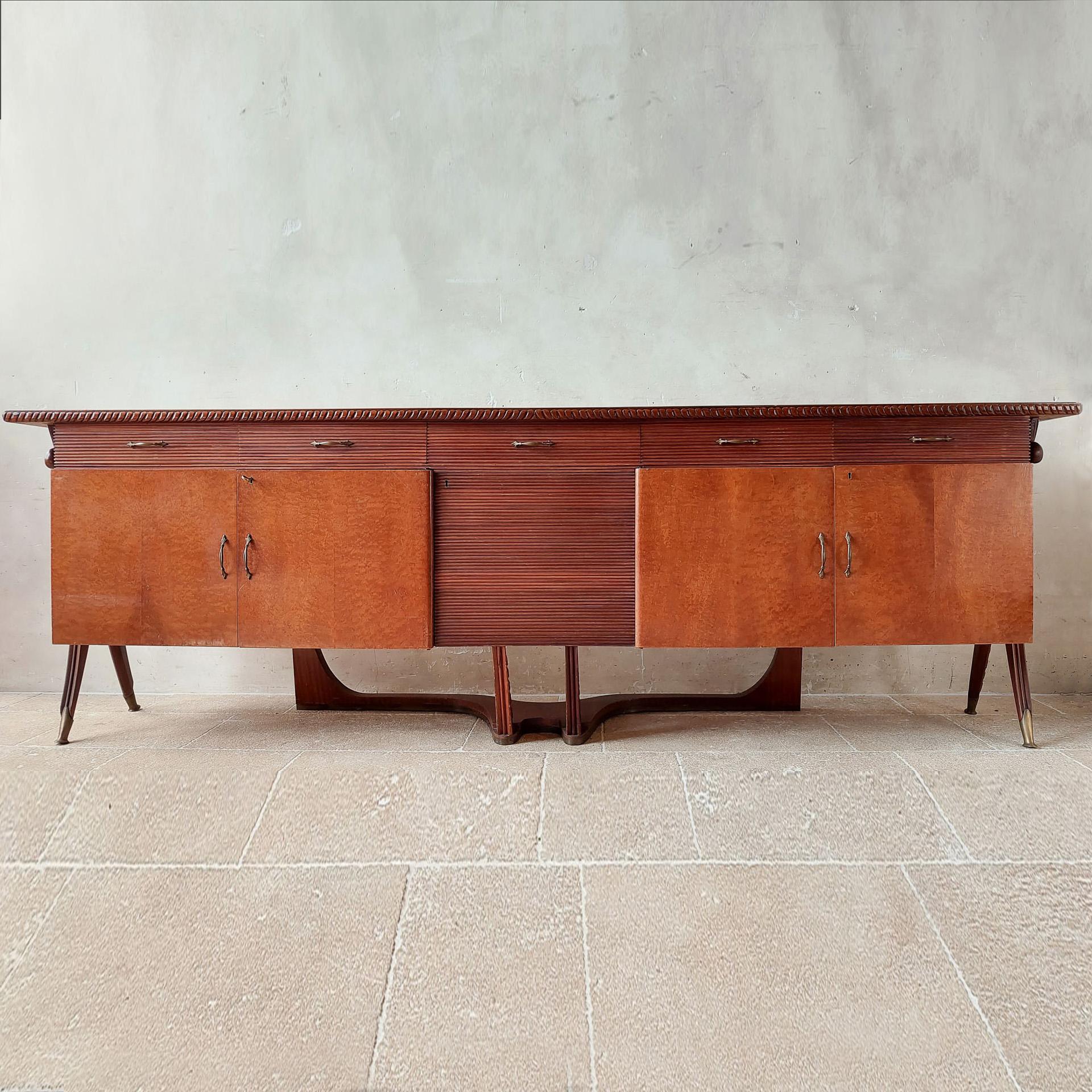 Mid-century Italian sideboard attributed to Osvaldo Borsani from the 1940s. This large, 3 meter wide cabinet, is made of walnut with lacquered parts and burl wood veneer, with beautiful patterned lines in the wood and patterns in the legs and the
