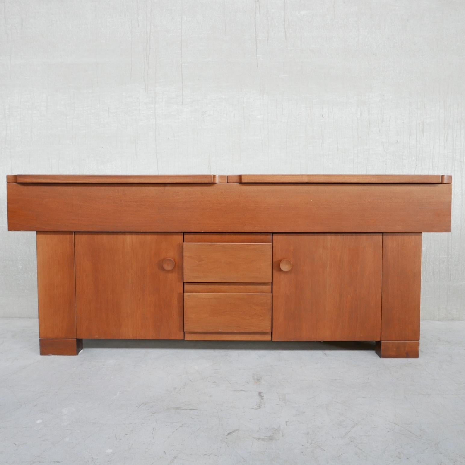 A walnut sideboard, by Giovanni Michelucci for Poltronova. 

'Torbecchia' model. 

Italy, c1960s. 

Drawers, to the front with two cabinets, the top also raises for additional storage options. 

Strong firm lines create a handsome look.