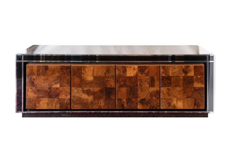 Midcentury Italian sideboard by Willy Rizzo.
Sideboard is finished with black glossy stained veneer surface decorated with chrome details and glass top.
It has four doors in burl veneer with internal shelves and drawers inside.
Very good vintage
