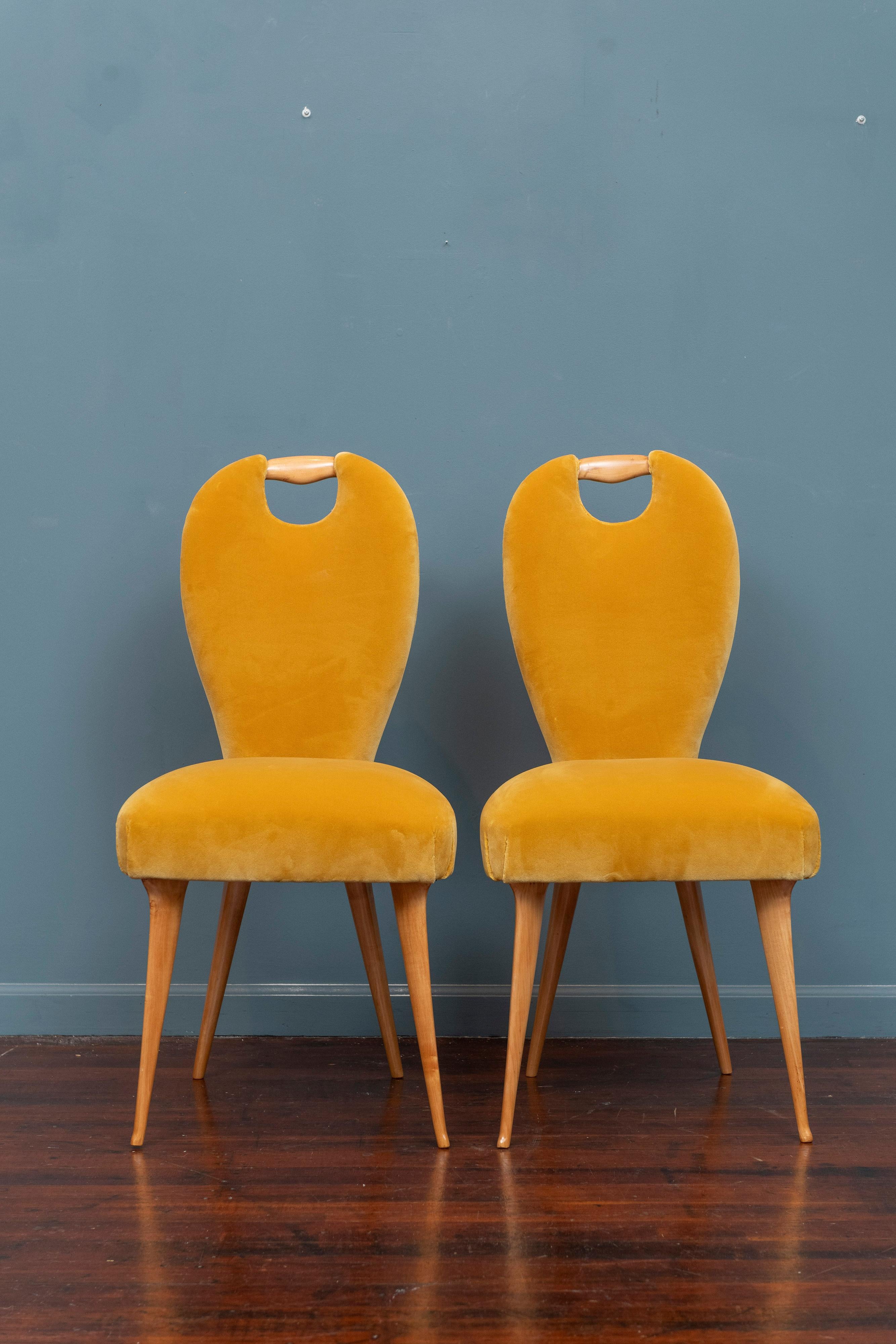 Mid-Century Italian side chairs attributed to Paolo Buffa. Newly rebuilt interior frames and refinished birch wood legs. Elegant form with a feminine torso silhouette and flared tapering legs and feet. Newly upholstered in gold velvet, solid sturdy